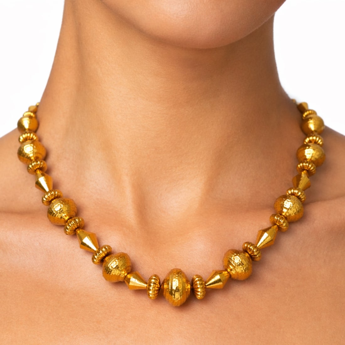 LALAOUNIS 18K Yellow Gold Necklace: LALAOUNIS 18K Yellow Gold Necklace, weighing 68.2 grams, crafted in a bold, ancient-inspired station design featuring alternating hammered gold beads and sculptural faceted links, finished with signat
