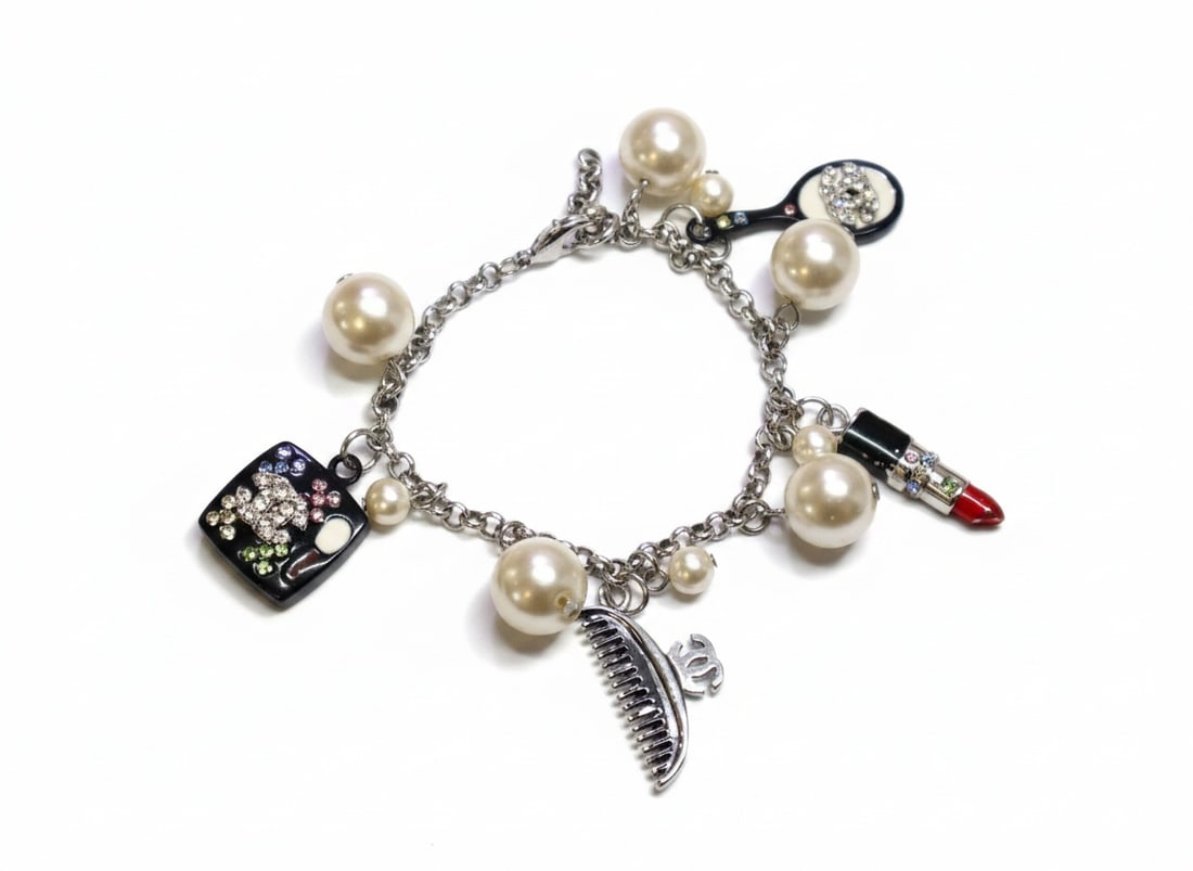 Chanel Vintage Make Up Charm Beaded Faux Pearl Chain Bracelet: This beautiful Chanel Bracelet features beaded faux pearls with chain links between and adorable acrylic beauty charms throughout. The charms include one round mirror with black backs and multi-colore