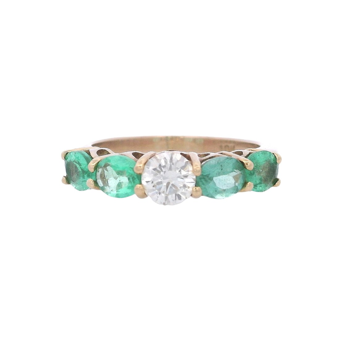 18kt yellow Gold Ring with 1.50 CTW in Emerald s & Diamond: 18kt yellow Gold Ring featuring a center Round cut Diamond of Approx. 0.50 carats. K color, VS1 clarity. Accenter with four Oval cut Emerald weighing together Approx. 1.00 carats. Ring size: 7. Total 