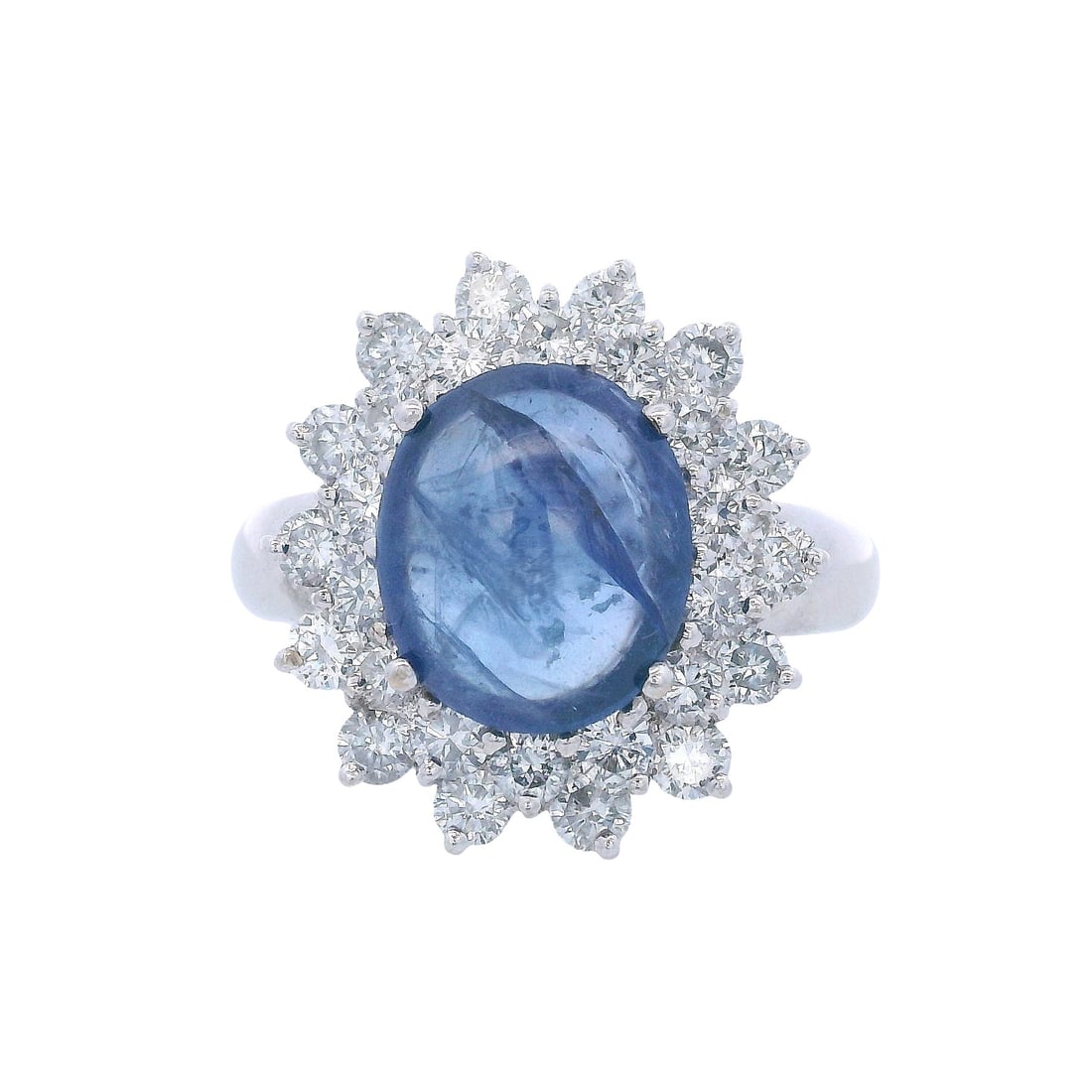 18kt white Gold Halo Ring with Sapphire & Diamonds: Halo Ring crafted from 18kt white Gold, featuring a center Oval cabochon Blue Sapphire of Approx. 3.00 carats. Surrounded by Round cut Diamonds weighing together Approx. 1.90 carats. F-G color, VS2 Cl