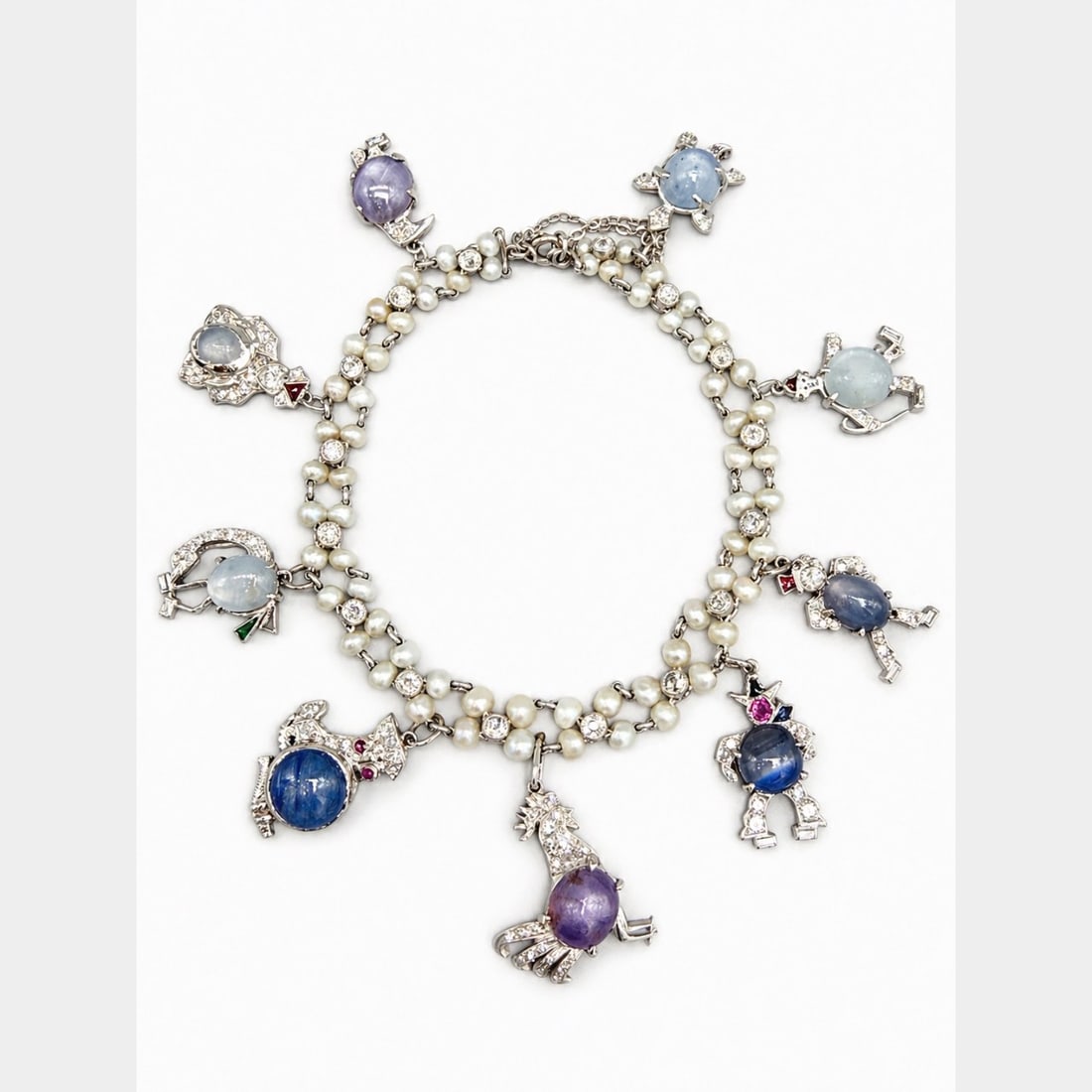 Art Deco Platinum Bracelet with 1.50 CTW in Diamond, and Natural Pearl: Art Deco Platinum Natural Pearl & Diamond Bracelet, weighing 15.1 grams, beautifully composed with 64 natural pearls in a classic double-strand design, punctuated by diamond-set stations for refined s