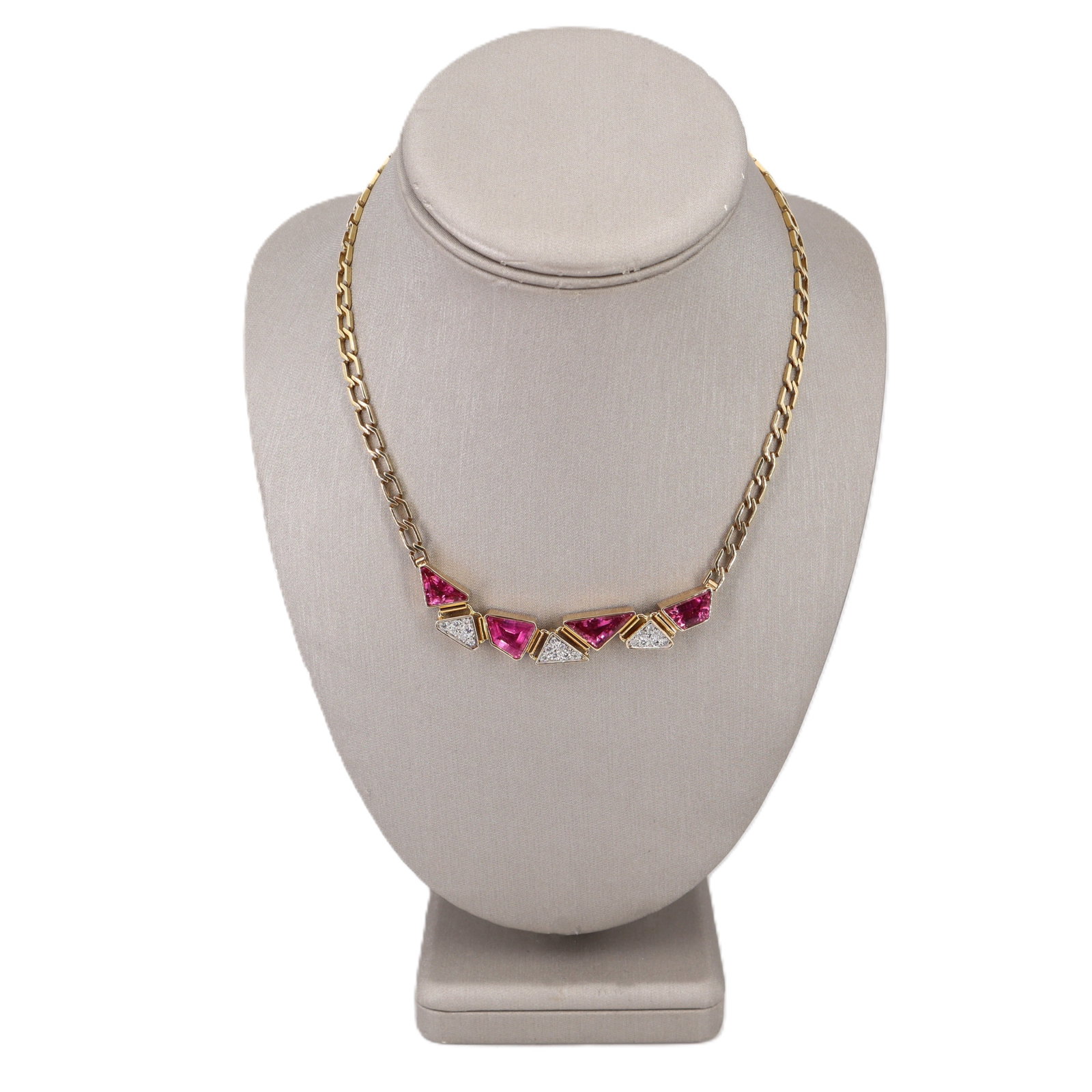 18K Yellow Gold Geometric Necklace with 7.66 CTW in Pink Tourmaline & Diamond: Striking in its clean, architectural lines, this geometric necklace is crafted in 18K yellow gold and set with four vibrant pink tourmalines totaling approximately 7.00 carats, creating a bold sweep o