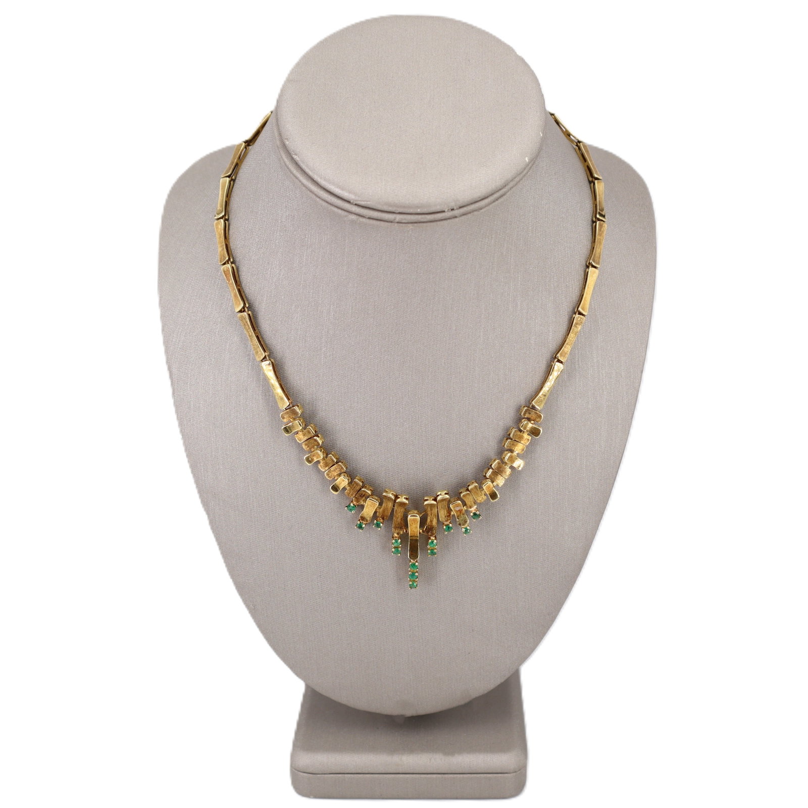 18K Yellow Gold Bamboo Necklace with 0.65 CTW Emeralds: Beautifully crafted in 18K yellow gold, this bamboo-style necklace features 13 round-cut emeralds totaling approximately 0.65 CTW, adding crisp, vivid green accents that pop against the warm gold link