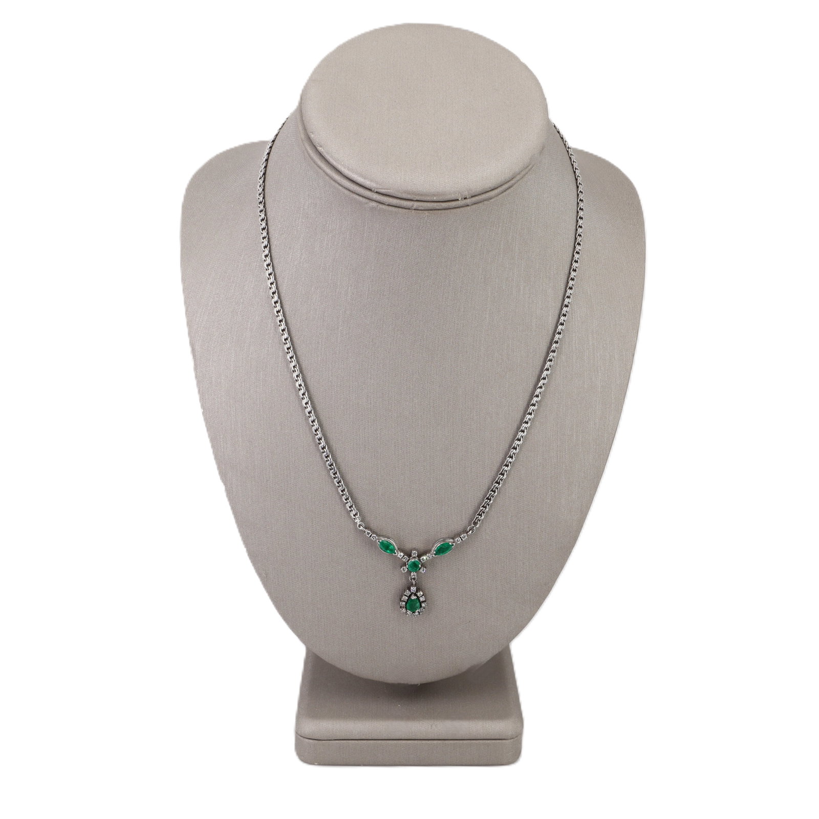 Vintage 18K White Gold Drop Necklace with 3.50 CTW in Emeralds & Diamonds: Vintage and irresistibly elegant, this 18K white gold necklace showcases four vivid green emeralds—a refined mix of pear, round, and marquise cuts—totaling approximately 3.00 carats, arran