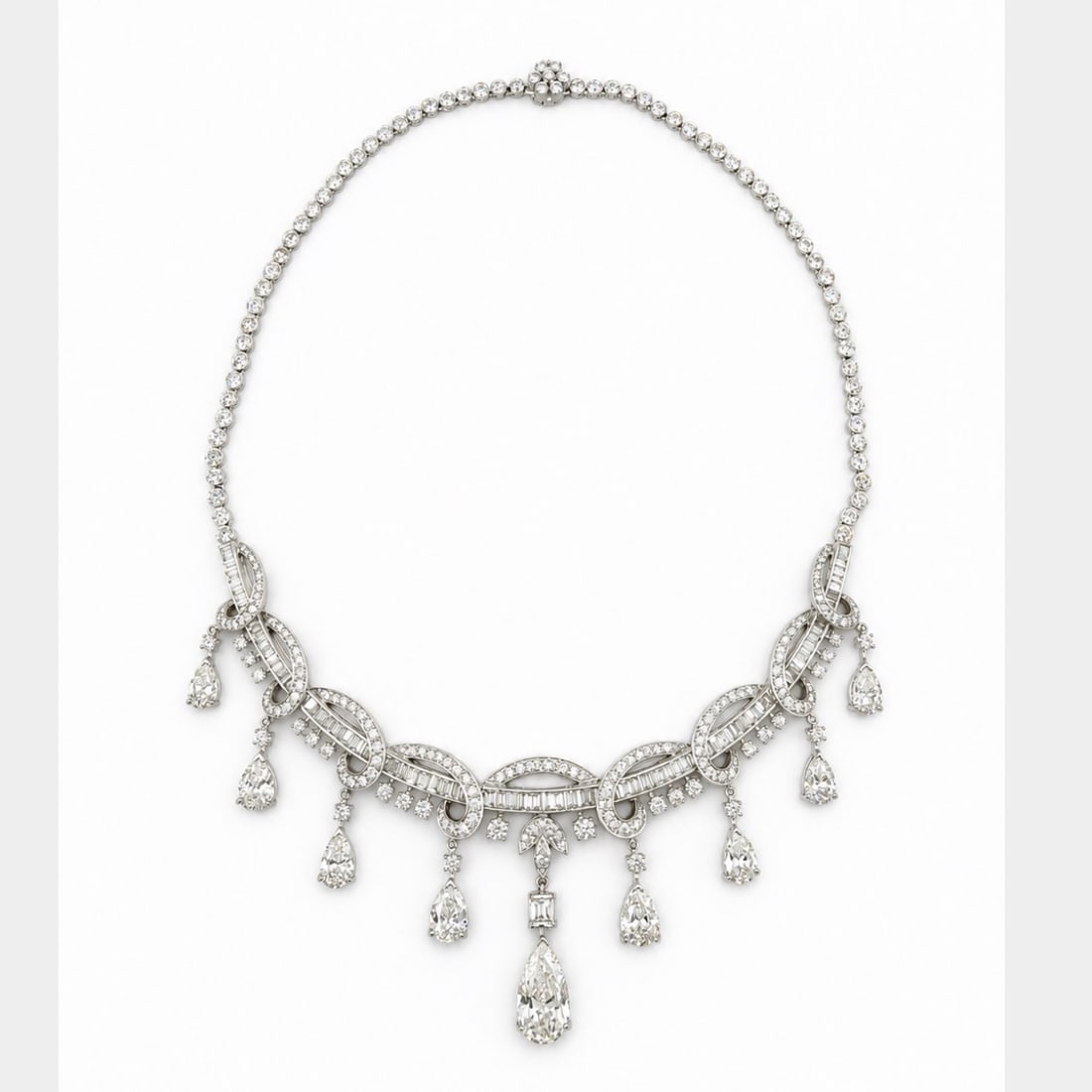 1950’s Platinum Necklace with 33.30 CTW in Diamond: 1950’s platinum diamond necklace set with a pear-shaped center diamond weighing approximately 4.00 CTW in K color and I1 clarity, accented by eight pear-shaped diamonds totaling approximately 9.