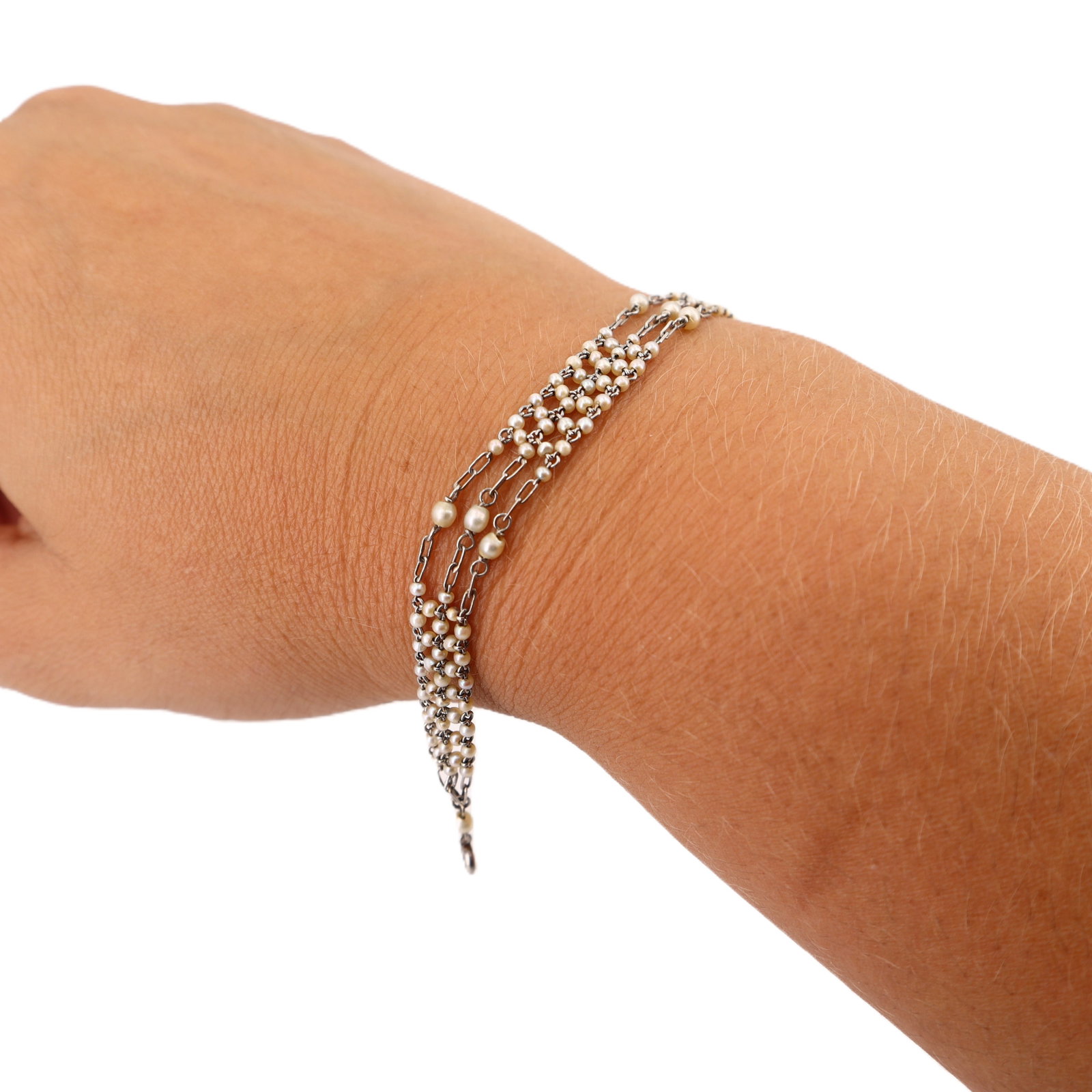Belle Epoque Antique Platinum Bracelet with Natural Pearls: Belle Époque Antique Platinum Bracelet, circa 1900-1915, weighing 4.7 grams, is masterfully crafted in platinum and adorned with 188 natural pearls in graduated sizes creating an exquisite milleg