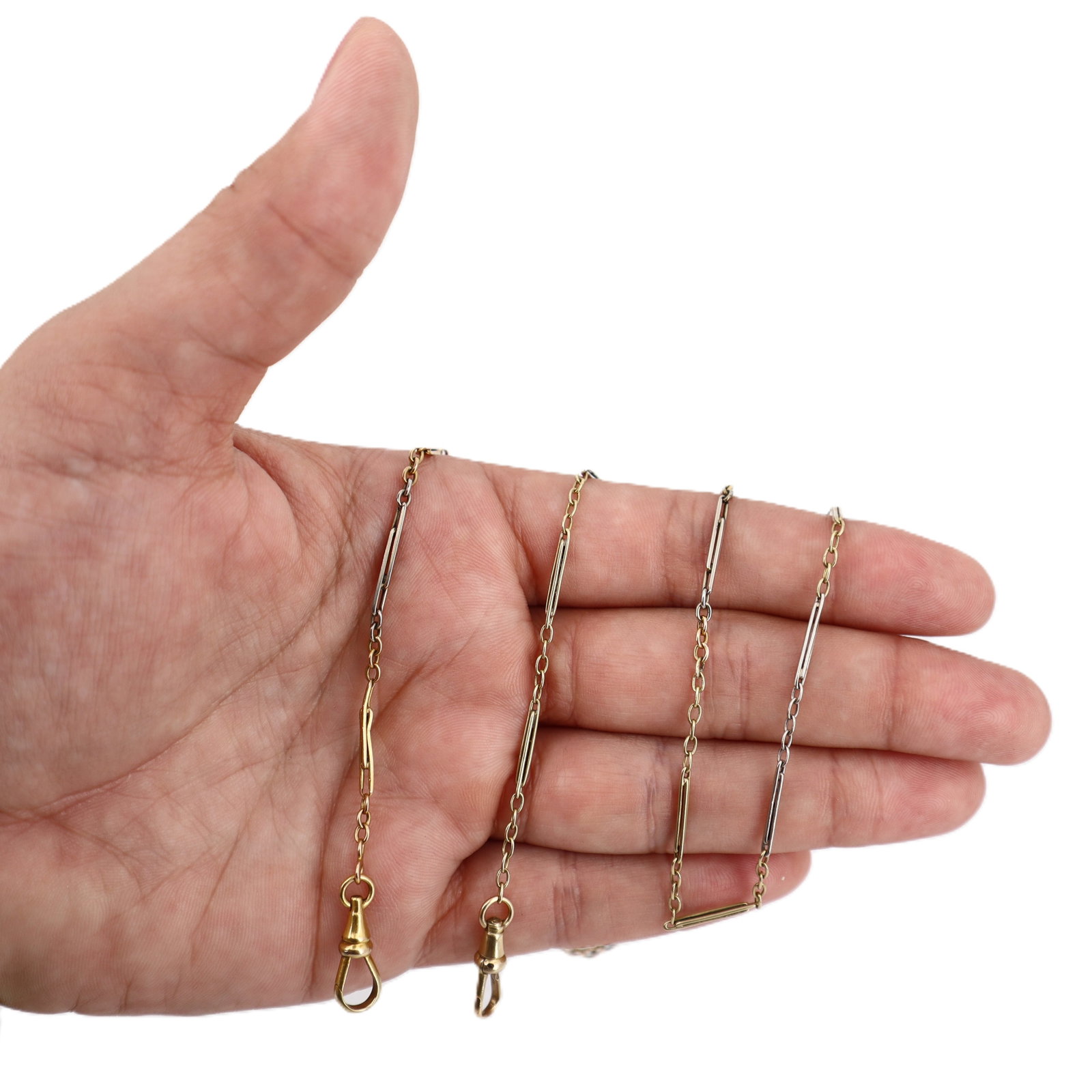 Antique 18kt yellow and white Gold Pcket Watch Chain Necklace: Antique Pocket Watch Chain Necklace, circa early 1900s, weighing 13.6 grams, is crafted in 18kt yellow and white gold featuring alternating gold tones in a classic chain design. This elegant piece mea