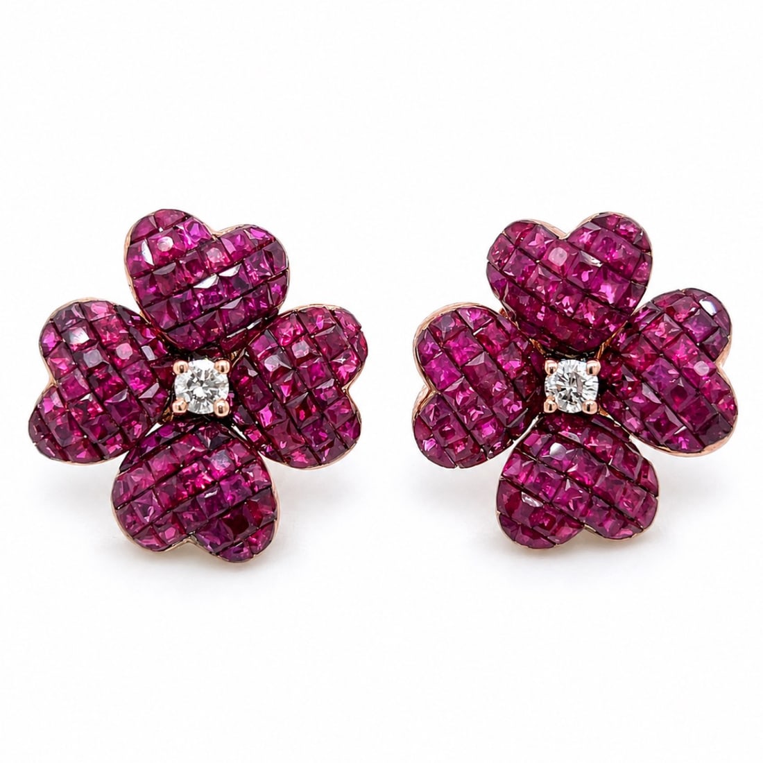 18K Rose & Yellow Gold Earrings with 10.25 CTW in Ruby & Diamond: 18K rose and yellow gold ruby and diamond earrings set with 208 rubies totaling approximately 10.00 CTW, accented with two diamonds totaling approximately 0.25 CTW in J color and SI1–I1 clarity.