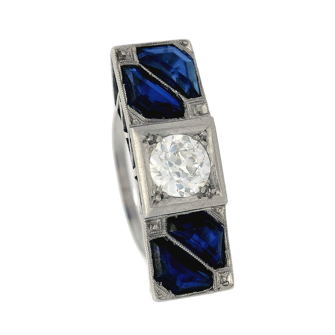 Art Deco Platinum Ring with Old mine Diamond and Sapphires: Circa 1920´s. Art Deco Ring crafted in Platinum featuring a center Old mine Diamond weighing Approx. 1.10 Carats H-I color, VS clarity. Along with four faceted synthetic blue Sapphires weighing t