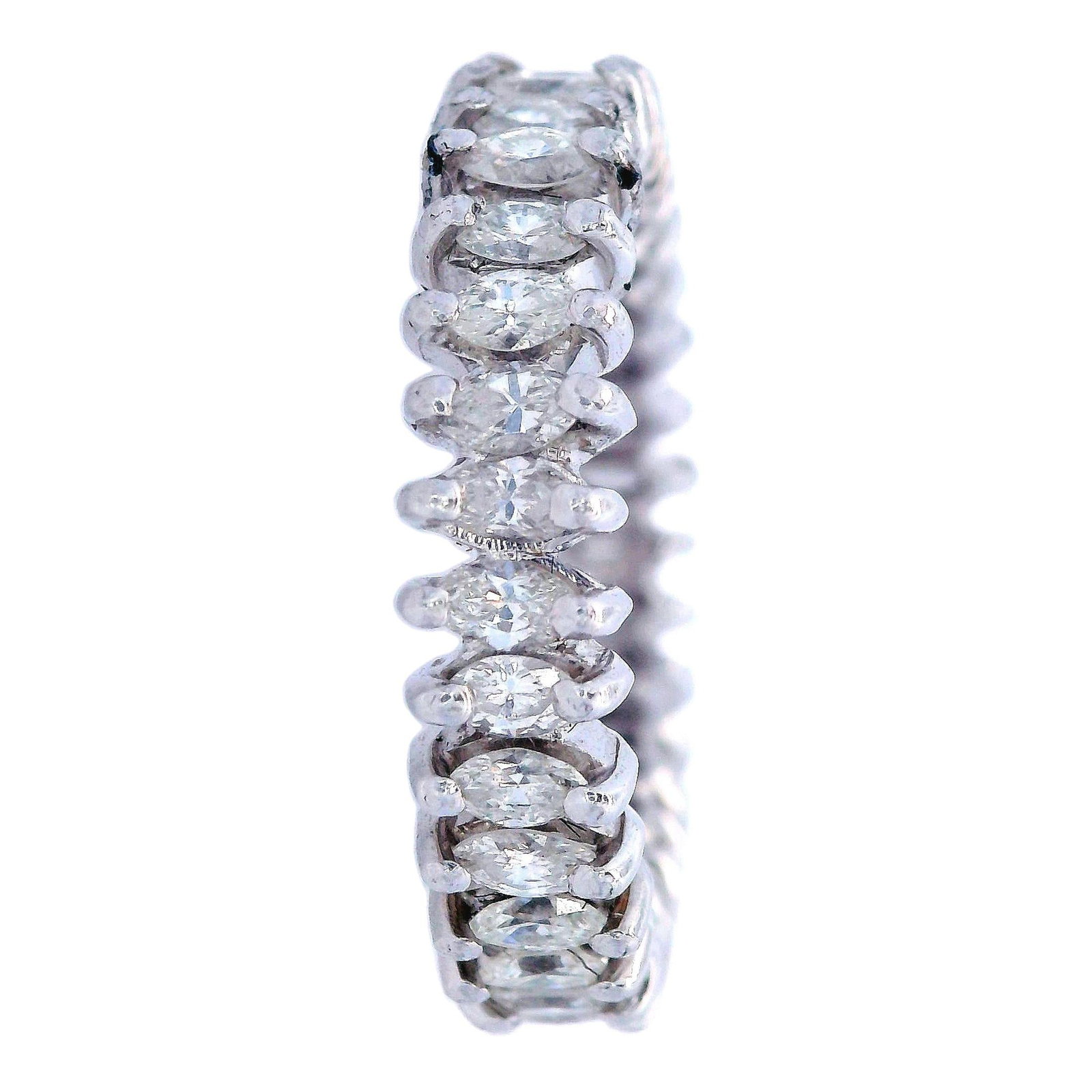 Vintage 2.60 Cts Marquise Diamonds Platinum Eternity Ring: The 1960-70s Vintage Eternity Band, weighing 4.8 grams, is crafted in platinum and features 32 marquise cut diamonds totaling approximately 2.60 carats (H-J color, VS-SI clarity). This elegant piece