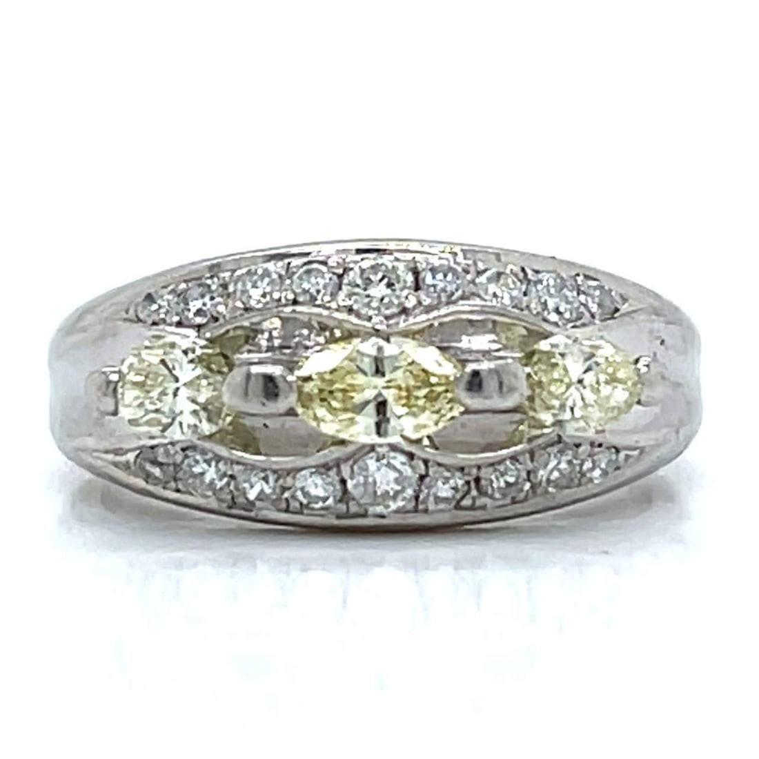Platinum Ring with 0.96 CTW in Fancy Intense Yellow Diamond & Diamond: Platinum fancy yellow diamond ring set with three fancy intense yellow marquise diamonds totaling 0.64 CTW (stamped weight) in VVS–VS clarity, accented with 18 diamonds totaling 0.32 CTW in