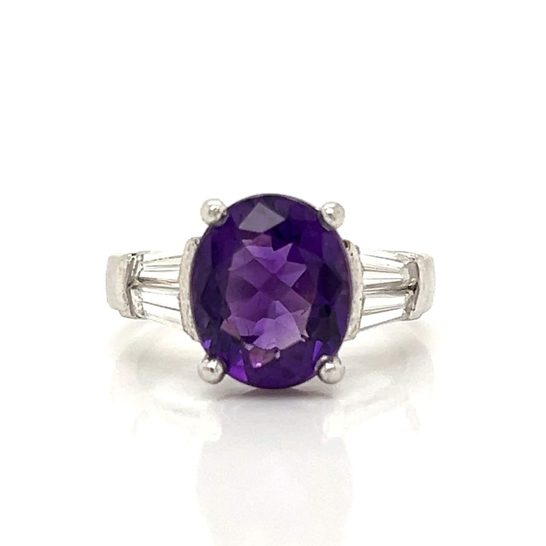 Platinum Ring with 5.50 CTW in Amethyst & Diamond: Platinum amethyst and diamond ring set with an approximately 4.00 CTW amethyst, accented with diamonds totaling approximately 1.50 CTW, for a combined total stone weight of approximately 5.50 CTW. Rin