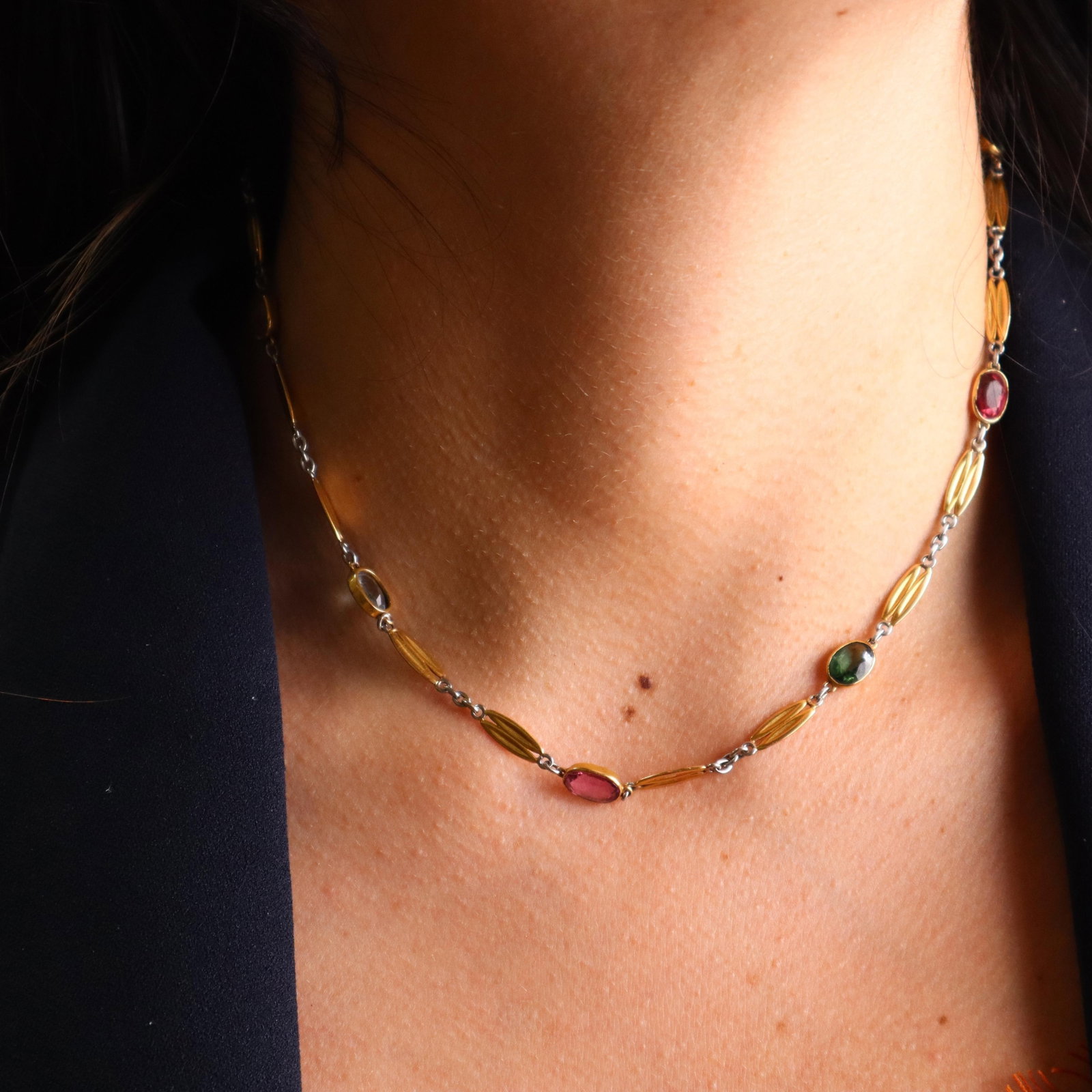 Art Deco 1920 18k yellow Gold and Platinum Necklace with multicolor Gemstones: The 1920s Art Deco Multi-Gemstone Necklace, weighing 14.8 grams, is crafted in 18k yellow gold and platinum featuring bezel-set oval natural gemstones including four Brazilian aquamarines, one citrine
