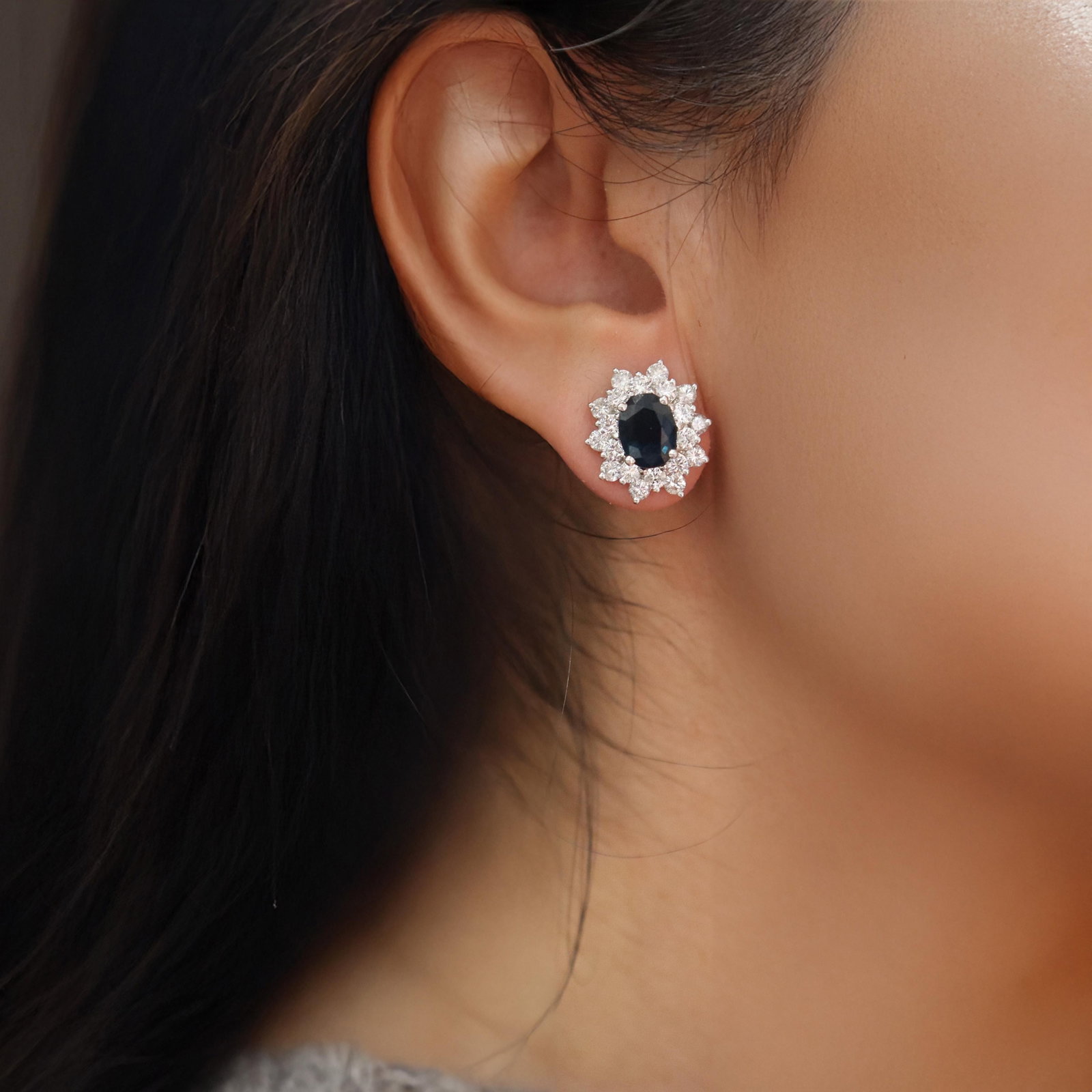 Modern 18k white Gold Studs Earrings with 7.30 CTW in Sapphires and Diamonds: These exquisite modern stud earrings weighing 6.24 grams are expertly crafted in 18k white gold and measure 0.63 x 0.56 inches. Feature two natural oval-shaped blue-greenish sapphires (approximately 5