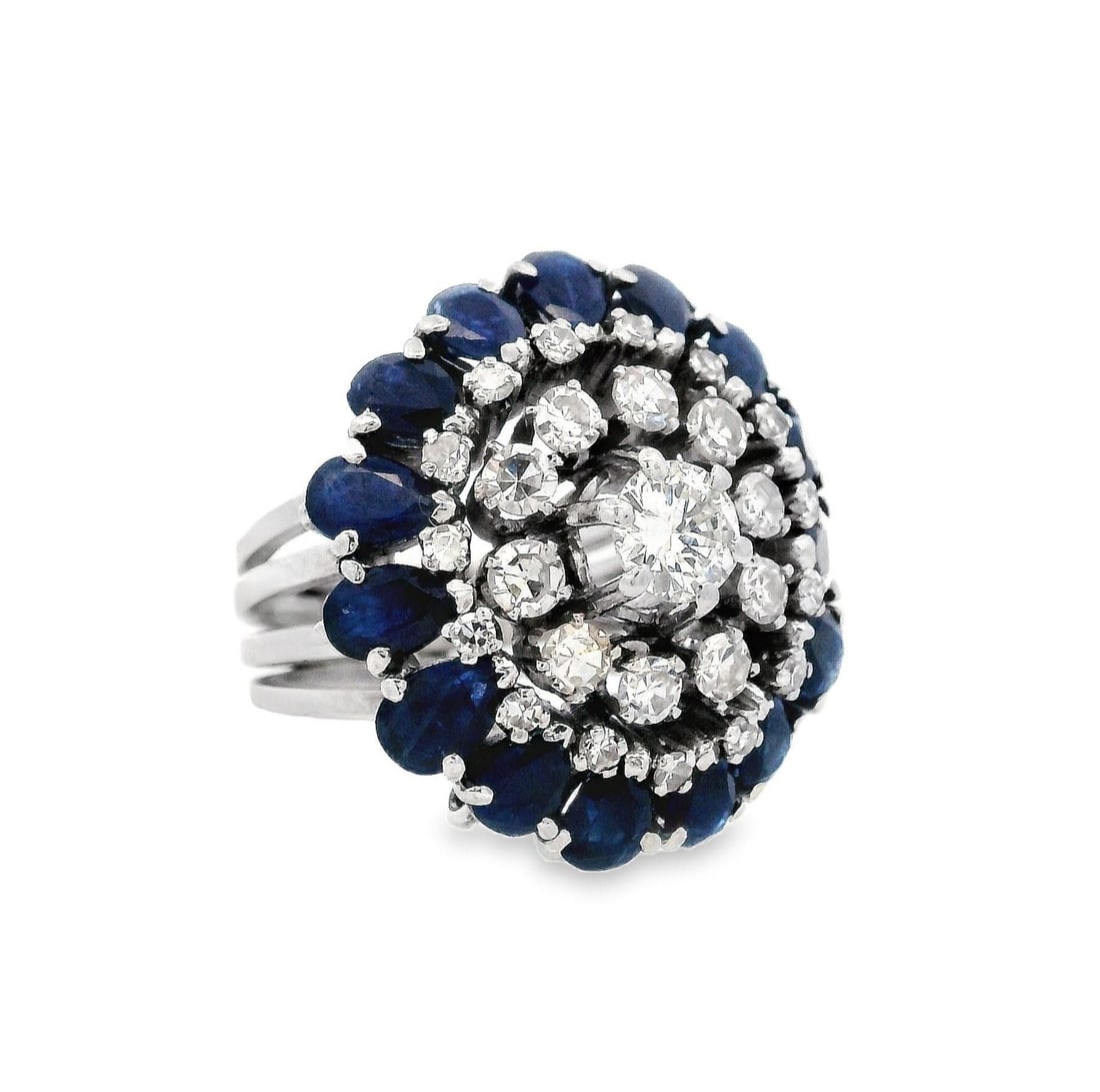 1950 Retro Platinum Ring with 4.50 CTW in Diamonds and Blue Sapphires: This exquisite retro ring in size 5 (resizable) weighs 14.1 grams and is expertly crafted in platinum with a width of 0.90 inches. Features a captivating full cut diamond center stone (approximately 0