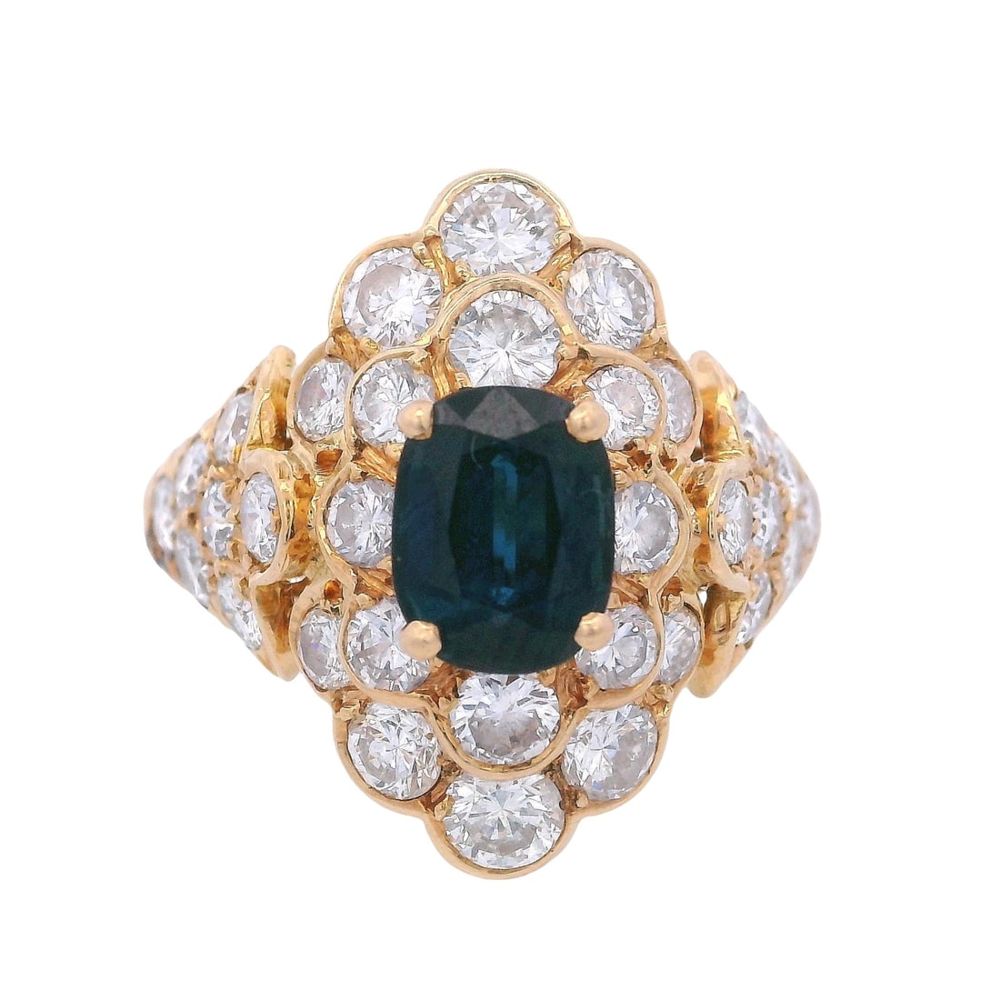 Retro 18K Yellow Gold Cocktail Ring with 2.60 CTW in Blue Sapphire & Diamond: Bold Retro 18K yellow gold cocktail ring showcasing an oval blue sapphire of approximately 1.00 carat, framed by a brilliant halo and sweeping diamond-set shoulders with round diamonds totaling approx
