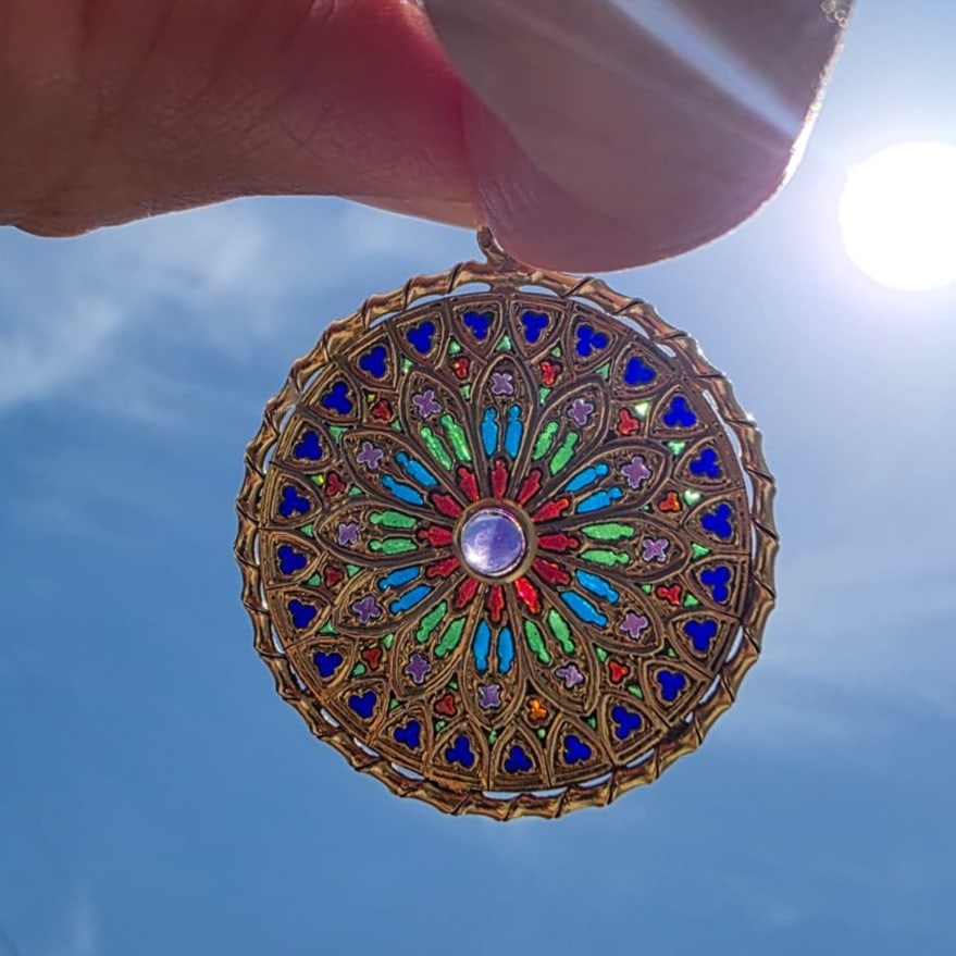 Antique French 18K Yellow Gold Pendant with Plique a Jour Enamel & Amethyst: Antique French 18K yellow gold pendant showcasing exquisite plique-à-jour enamel in vivid green, blue, and red, arranged in a radiant, stained-glass style design and centered by a cabochon amethy