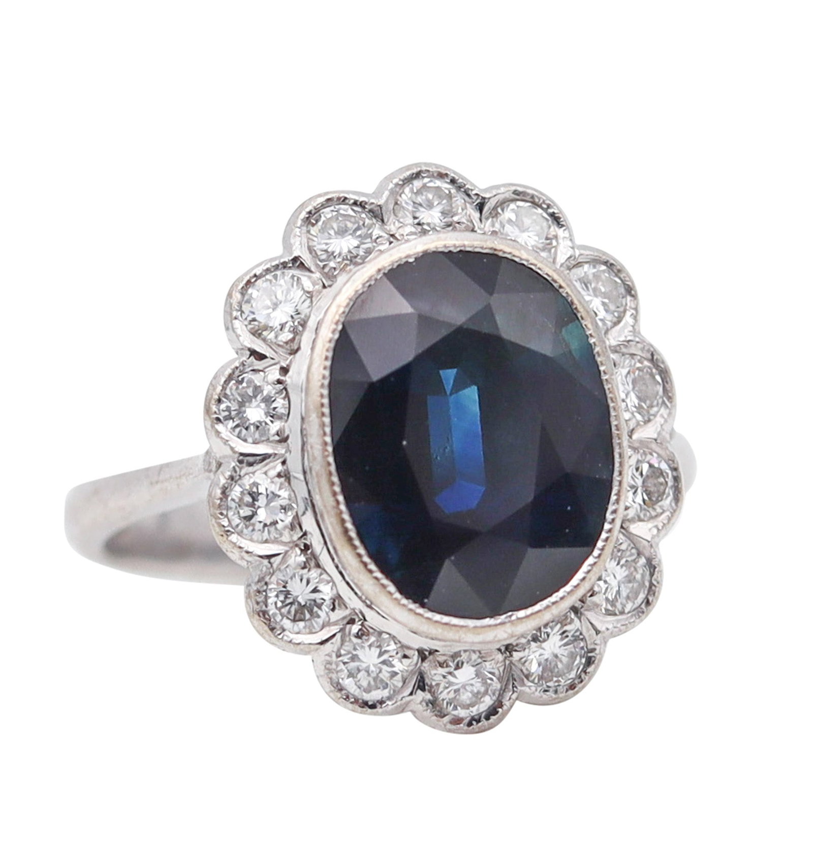 Art Deco 1930 Cocktail Ring In 18Kt White Gold With 5.06 Ctw In Diamonds And Sapphire: Beautiful Art Deco cocktail ring, America, circa 1930, crafted in solid 18K white gold with a polished finish and crisp millegrain detailing to the settings. Centered with an oval faceted blue sapphir