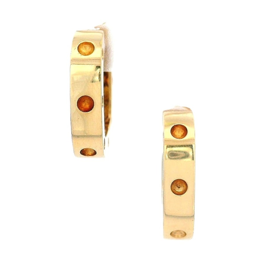 Roberto Coin 18K Yellow Gold Hoop Earrings: Roberto Coin hoop earrings in polished 18K yellow gold, accented with the brand’s signature ruby details—a hallmark of the Italian house, traditionally placed as a “hidden ruby”