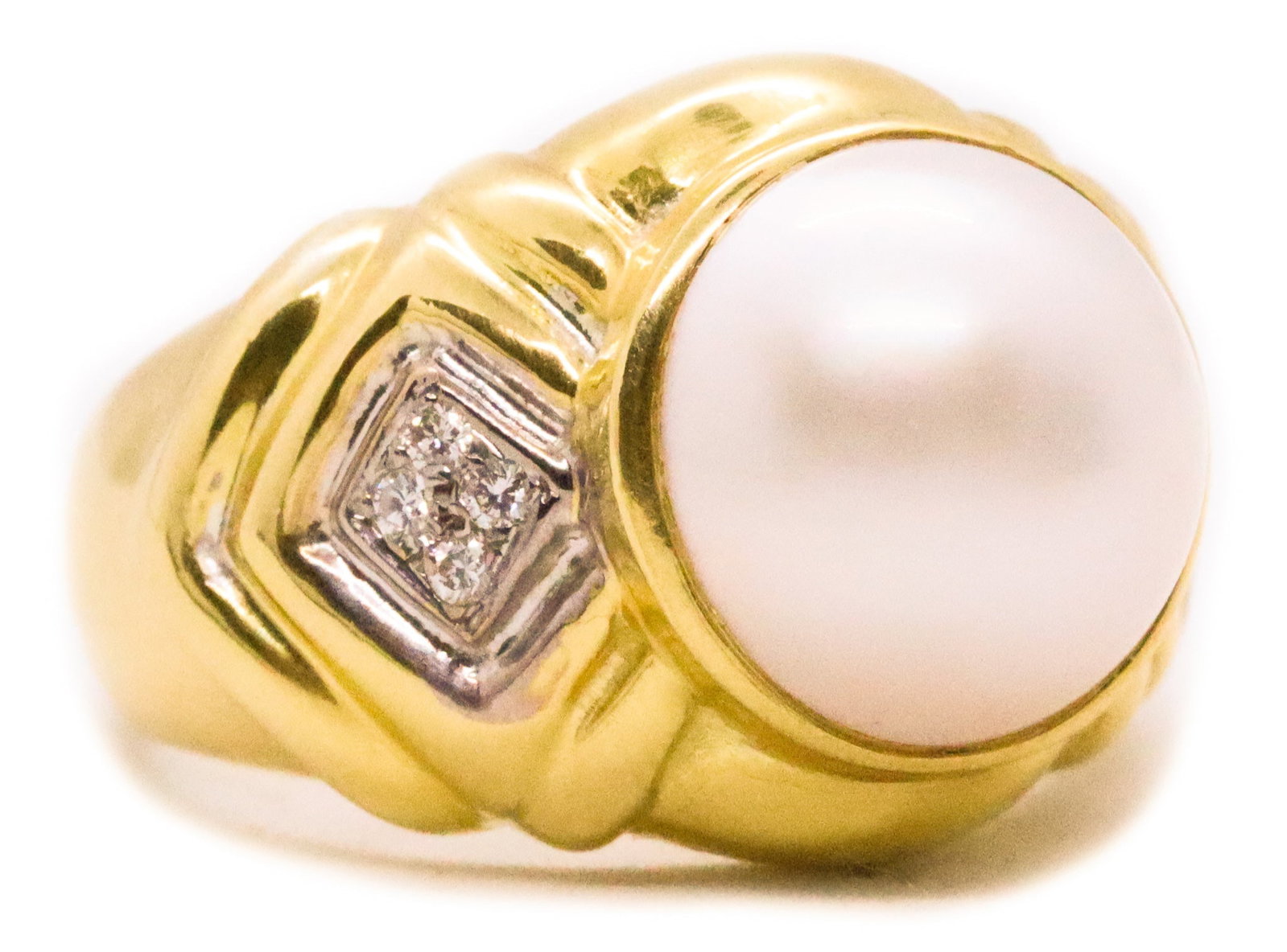 ITALIAN Modern Cocktail Ring In 18Kt Yellow Gold With Diamonds And White Pearl: Modern classic Italian ring crafted in solid 18K yellow gold with a high-polish finish, centered with an 11mm white Mabe pearl in a bezel setting. Accented at the shoulders with eight pavé-set ro