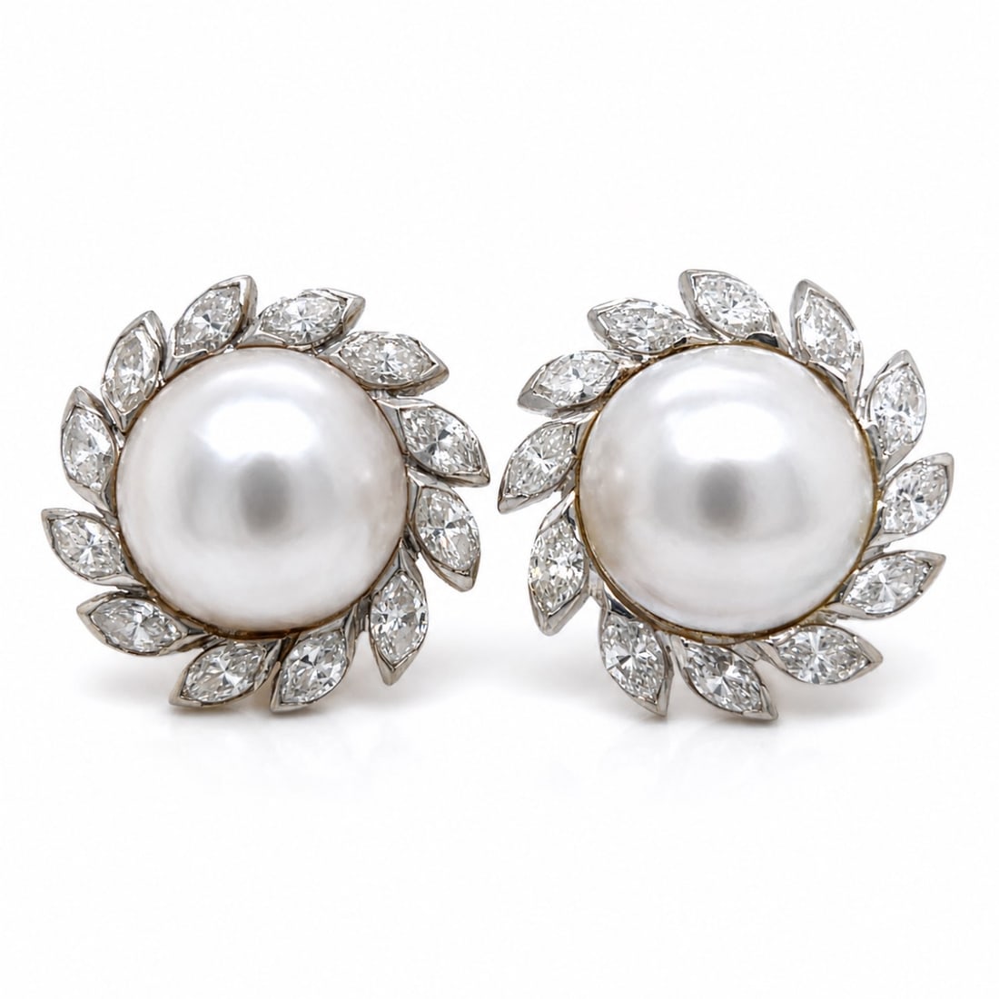 Mid-century 14K White Gold Earrings with 5.50 CTW in Diamond & Mabe Pearl: Chic circa 1960’s earrings crafted in 14K white gold, centered with luminous mabe pearls (15.6 mm) and framed by a bold halo of marquise-shaped diamond “petals” for a crisp, high-imp