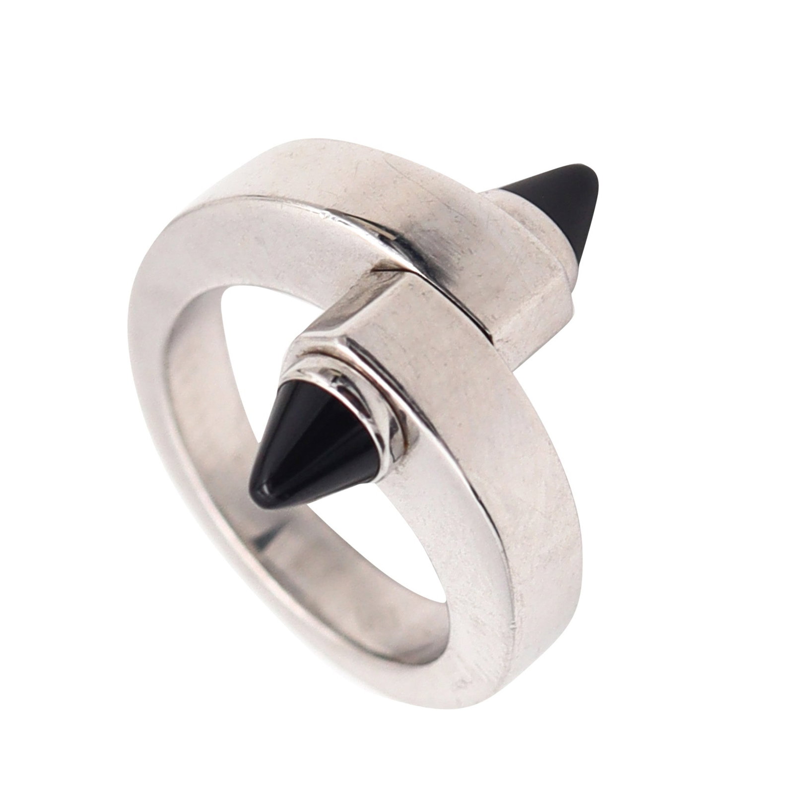 CARTIER Paris Geometric Menotte Bypass Ring In 18Kt Gold With Black Onyx Sz 51: Cartier Menotte bypass ring, Paris, crafted in solid 18K white gold with a high-polish finish and iconic industrial-inspired sculptural lines. Accented at the terminals with two bezel-set bullet caboc