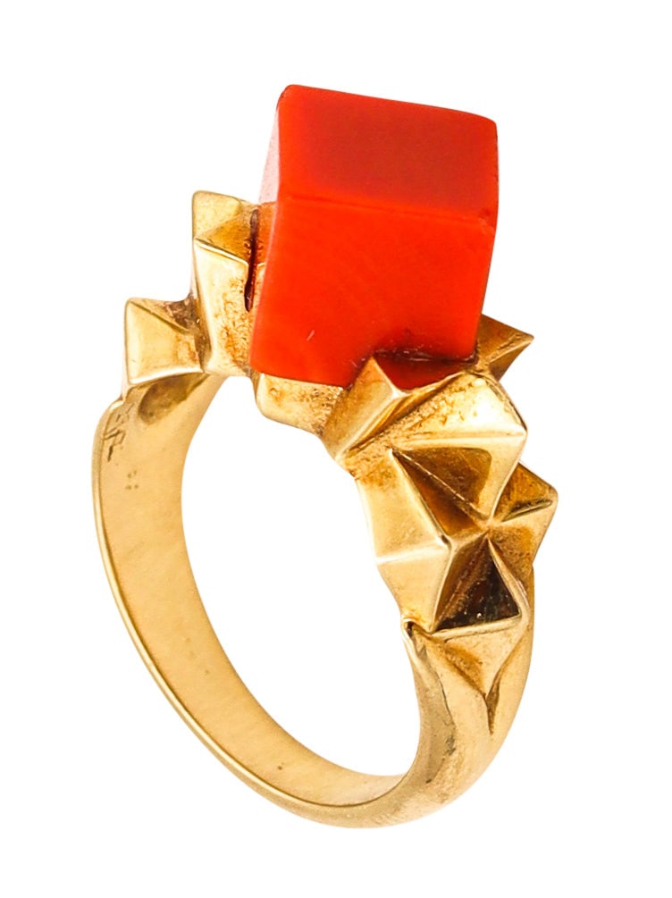 Tiffany & Co. 1970 By Donald Claflin Sculptural Ring In 18Kt Yellow Gold With Coral: Very rare sculptural geometric ring by Donald Claflin for Tiffany Studios, New York, circa 1970, crafted in solid 18K yellow gold with a high-polish finish. Topped with a cubic coral element carved fr