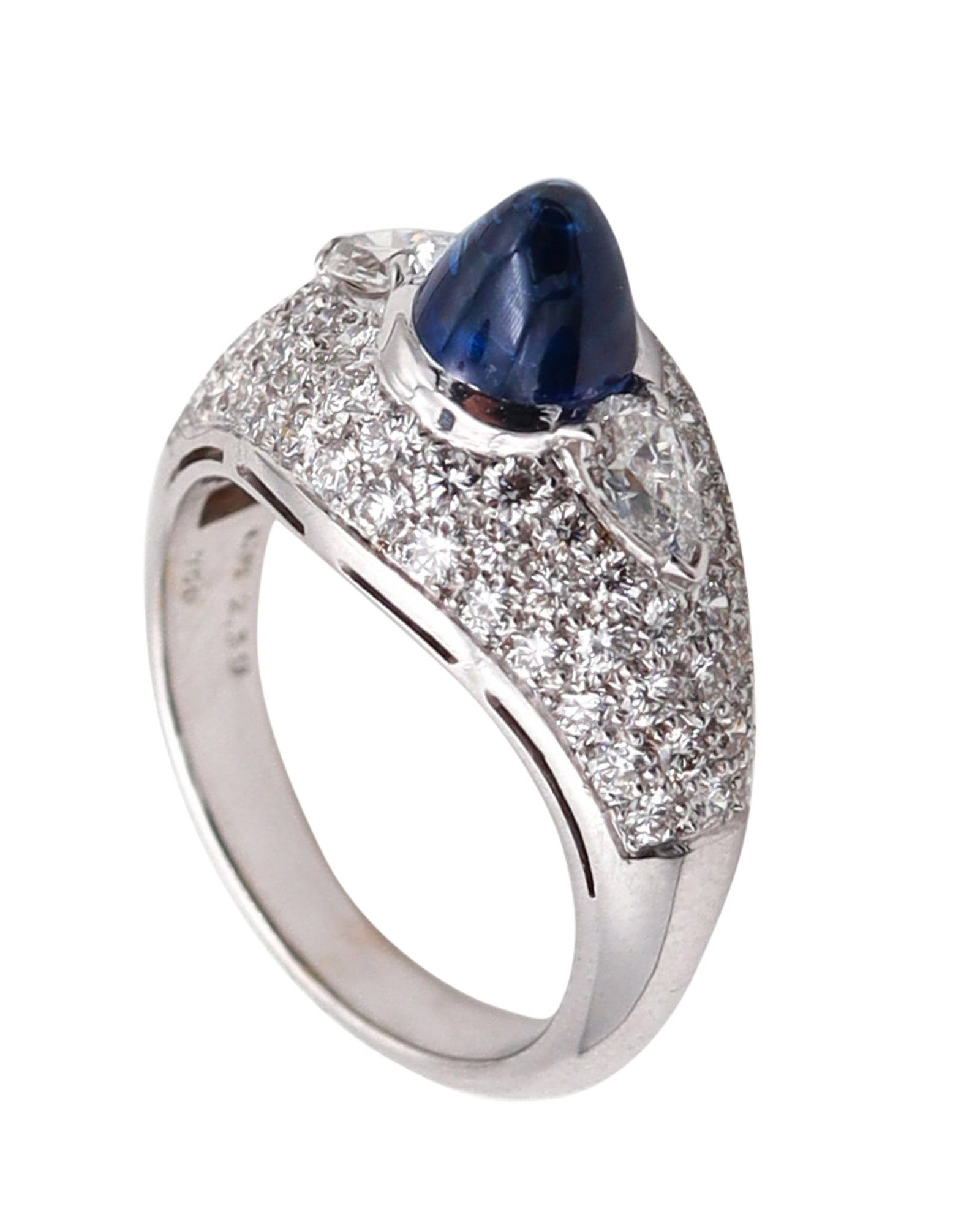 BVLGARI Cocktail Ring In 18Kt Gold With 4.74 Ctw In Diamonds And Sapphire: Extraordinary Bvlgari cocktail ring, Rome, crafted in solid 18K white gold with a high-polish finish and set with 77 natural gemstones. Centered with a bezel-set round sugarloaf cabochon intense blue 