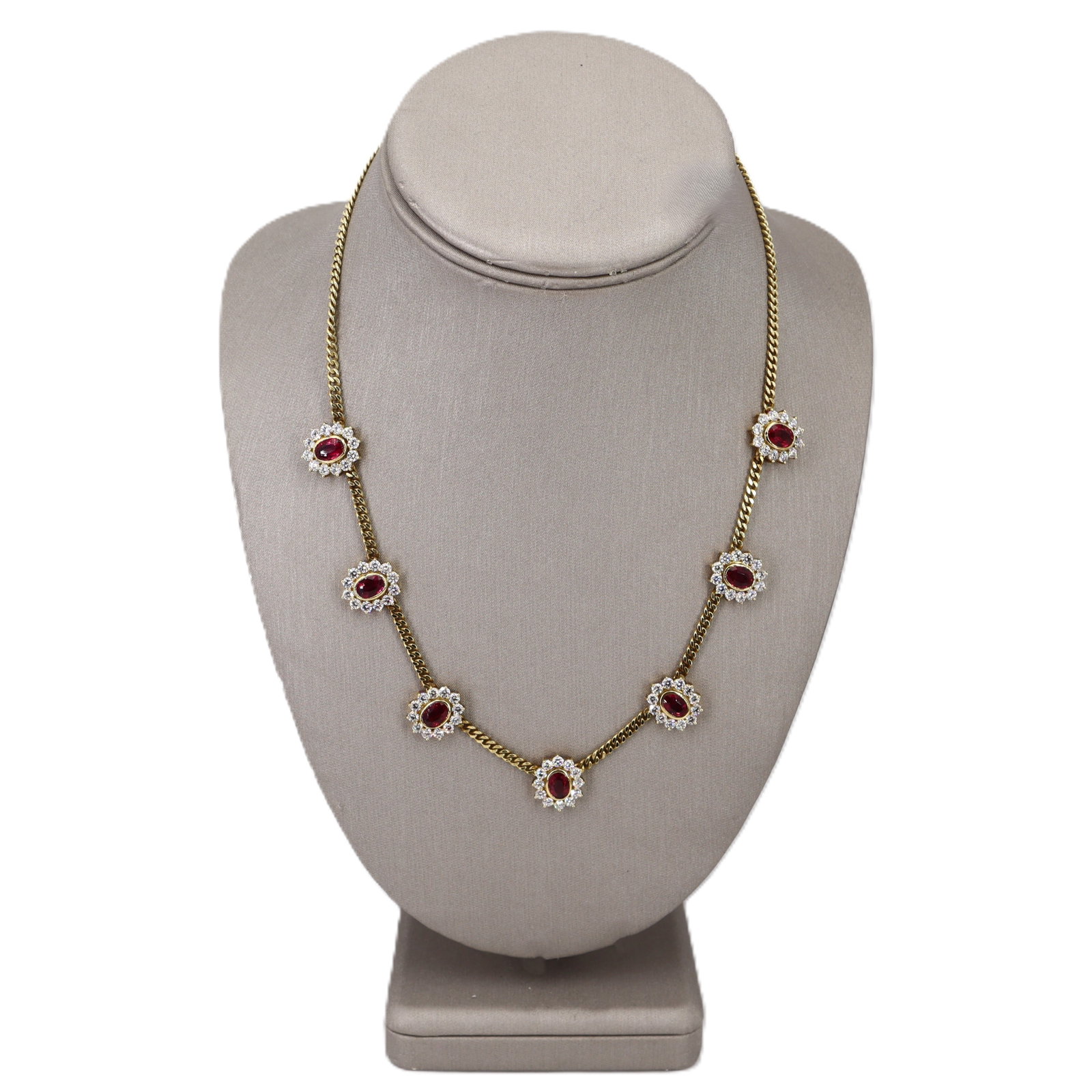 18K Yellow Gold Ruby Necklace with 11.25 CTW in Rubies & Diamonds: Beautifully crafted 18K yellow gold necklace featuring seven oval-cut, gem-quality rubies totaling approximately 5.50 carats, each framed by a sparkling halo of 84 round-cut diamonds totaling approxim