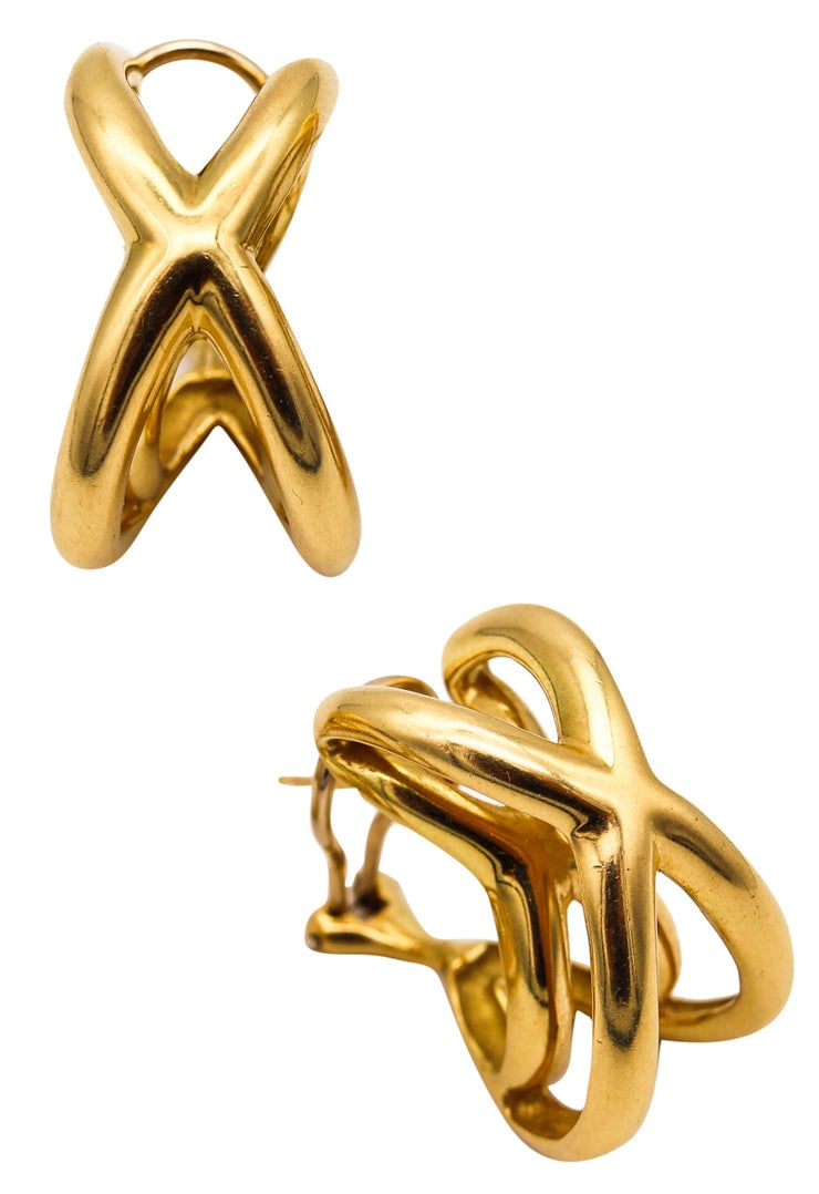 TIFFANY & CO. 1976-77 Donald Claflin Pair Of Crossover Earrings In 18Kt Yellow Gold: Three-dimensional oversized X crossover earrings by Donald Claflin for Tiffany & Co., 1976, crafted in solid 18K yellow gold with a high-polish finish and bold sculptural volume. Fitted with posts for
