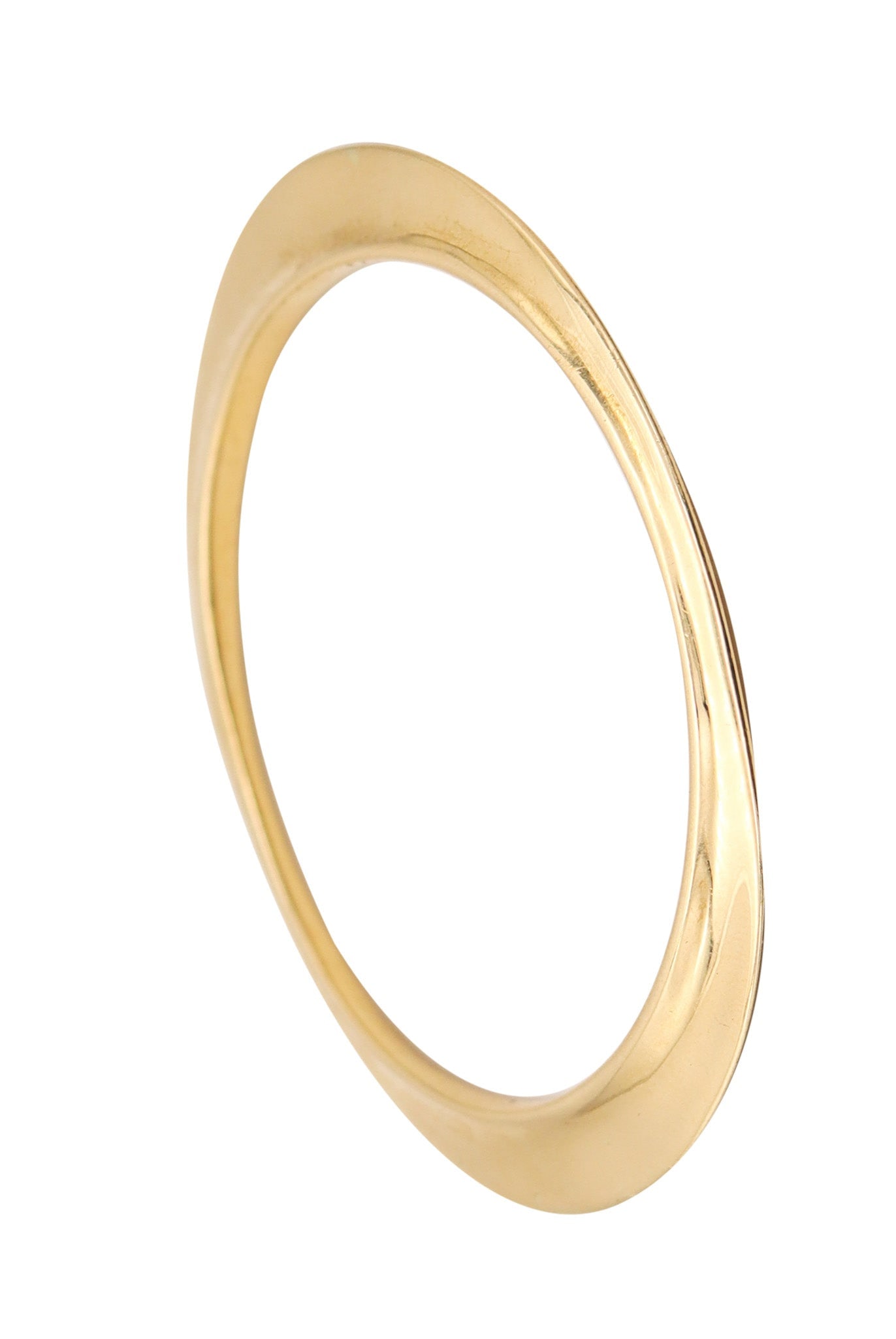 TIFFANY & CO. 1977 By Elsa Peretti Flying Saucer Bangle Bracelet In 18Kt Yellow Gold: Very rare Elsa Peretti “Flying Saucer” free-form bangle for Tiffany & Co., New York, 1977, crafted in solid 18K yellow gold with a high-polish finish and produced in very limited numbers. 
