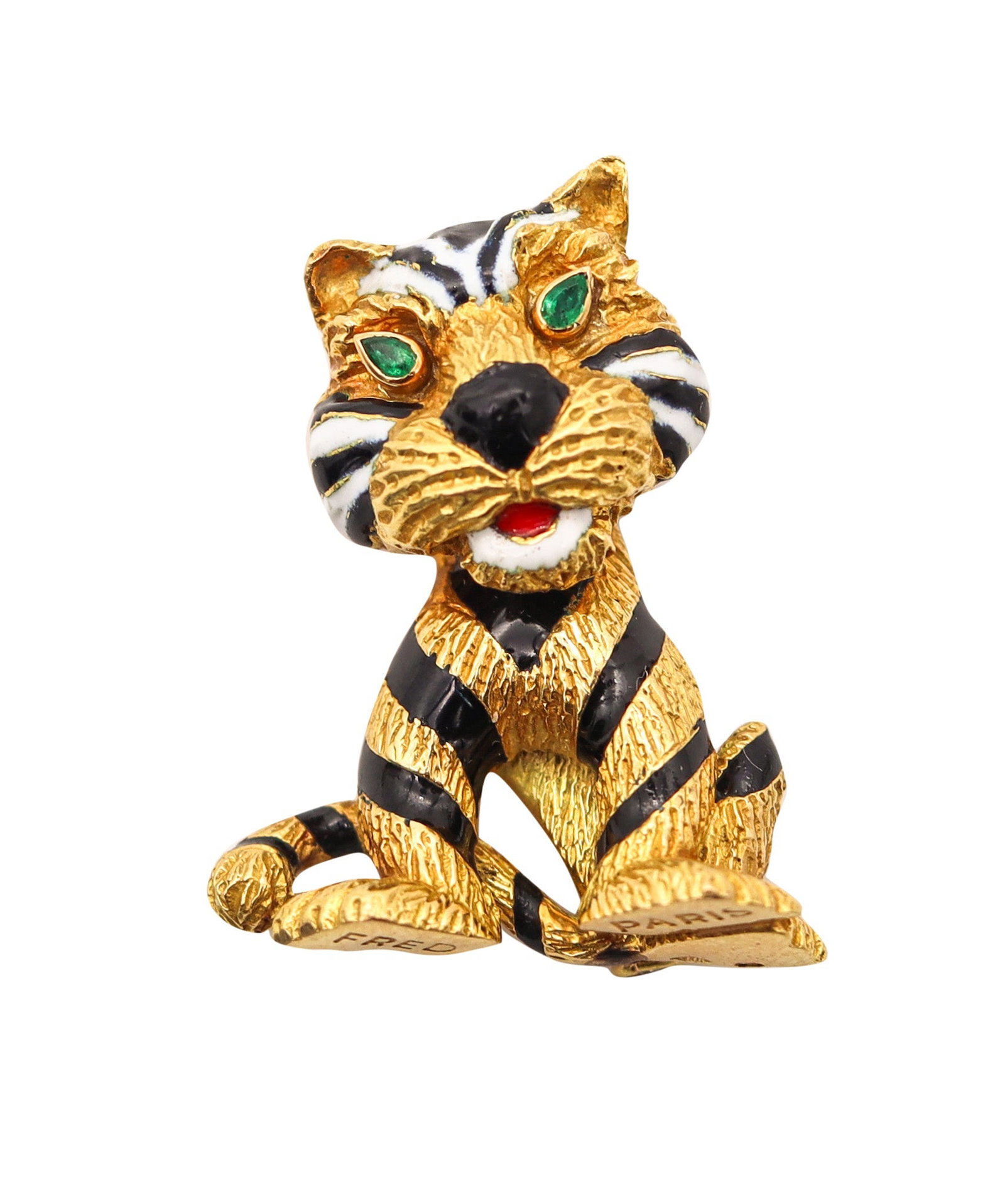 FRED PARIS 1970 Enameled Sauvage Lion Brooch In 18Kt Yellow Gold With Emeralds: Whimsical seated lion brooch by Fred of Paris, circa 1970s, one of the Maison’s most iconic designs. Crafted in solid 18K yellow gold with a textured finish, decorated with black, red, and white