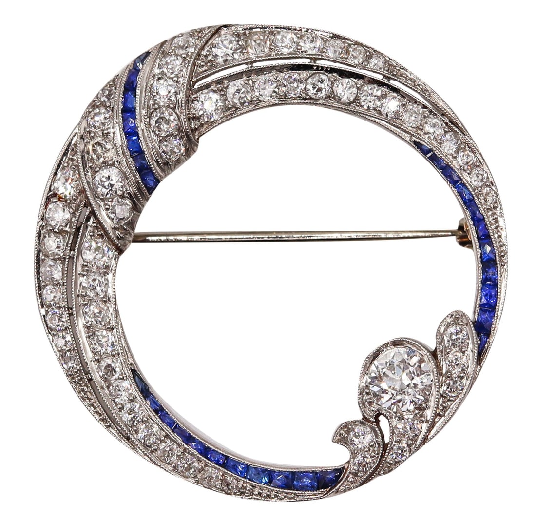 Hayden W. Wheeler & Co 1930's Art Deco Brooch In Platinum With 4.33 Cts In Diamonds & Sapphires: Very rare Art Deco rounded pin brooch by Hayden W. Wheeler & Co., New York, circa 1930s, crafted in solid .900 platinum with impeccable millegrain work and fitted with a horizontal hinged pin bar and 