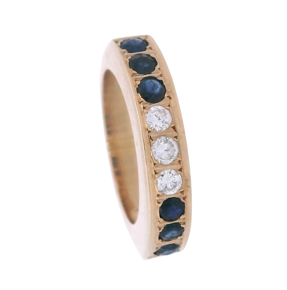 18kt yellow Gold Band Ring with Sapphires & Diamonds: 18kt yellow Gold Ring featuring three center Round cut Diamonds weighing together Approx. 0.15 carats. F-G color, VVS-VS1 calrity. Along with six Round cut Blue Sapphires weighing together Approx. 0.3