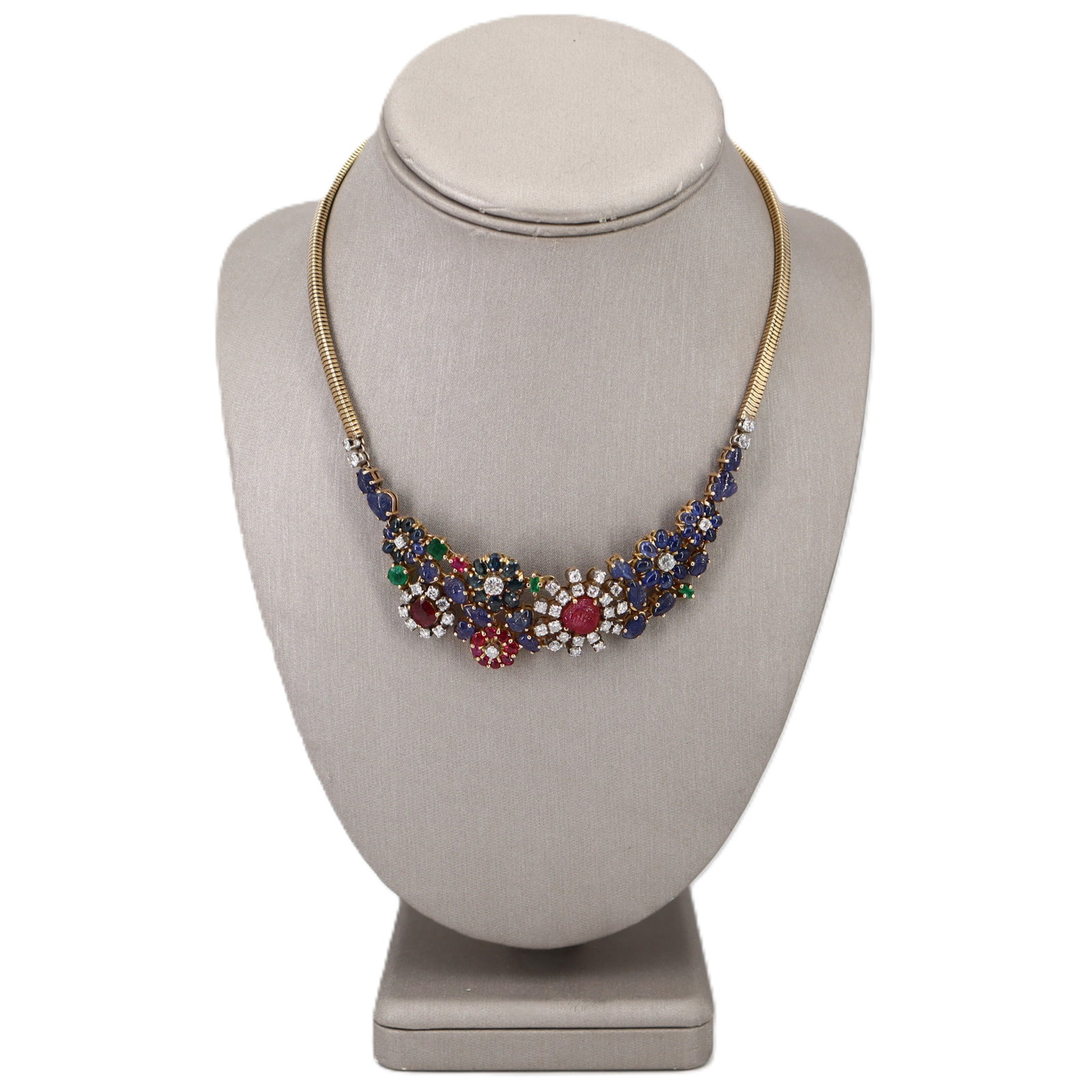 Retro 18K Yellow Gold Tutti Frutti Necklace with Diamonds, Rubies, Sapphires & Emeralds: Retro 18K yellow gold Tutti Frutti necklace featuring a flexible ribbed/snake-style chain and a gem-set floral garland centerpiece. Accented with diamonds totaling approx. 2.90 ctw (G?H color, VS?SI1 