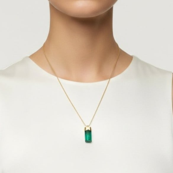 14K Yellow Gold Pendant with 12.0 CTW in Rough Emerald: Beautiful pendant crafted in 14K yellow gold, set with a rough intense green emerald weighing approx. 12.0 ctw in a sleek, elongated drop design. Measures approx. 1.15 x 0.38 inches. Total weight 3.9 