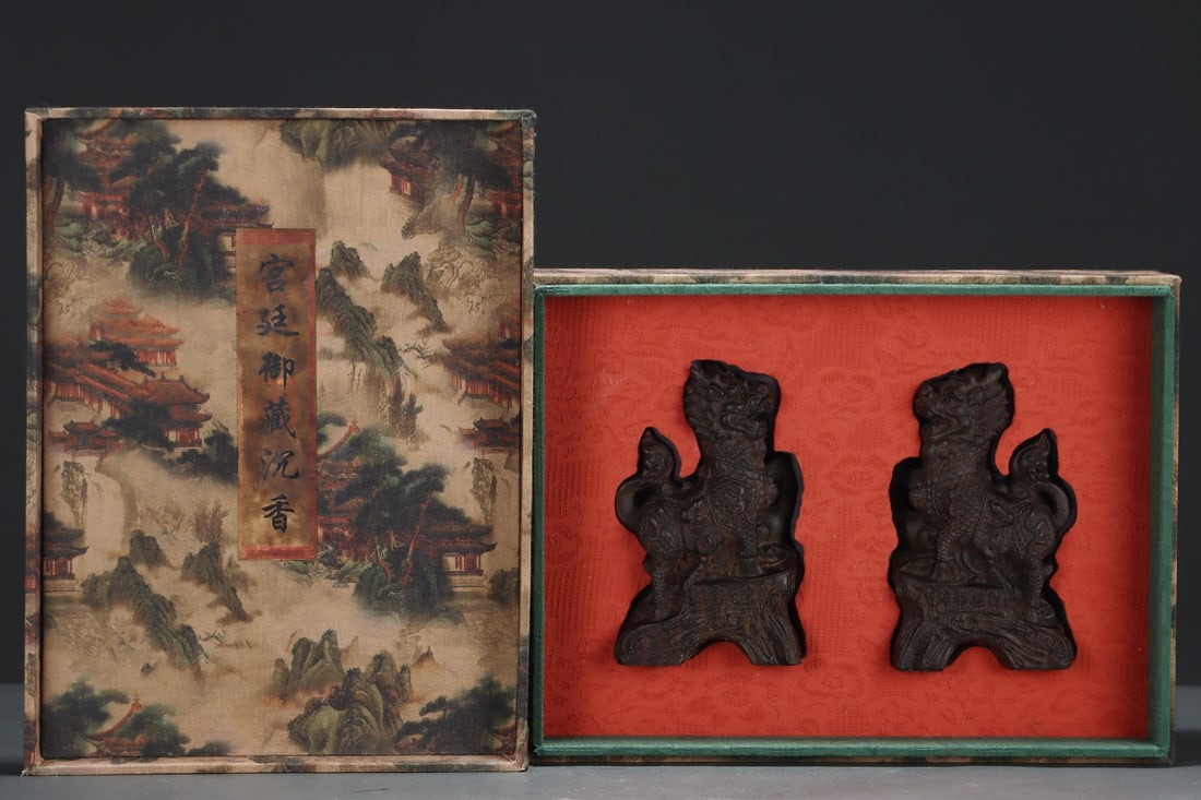 Old Collection of Agarwood Qilin Pair of Beasts: A pair of agarwood qilin and beast figurines, formerly in the collection. Dimensions: Length: 11.5 cm, Width: 5 cm, Height: 18.5 cm. Provenance:from the collection of George Stopher, Kent, purchased