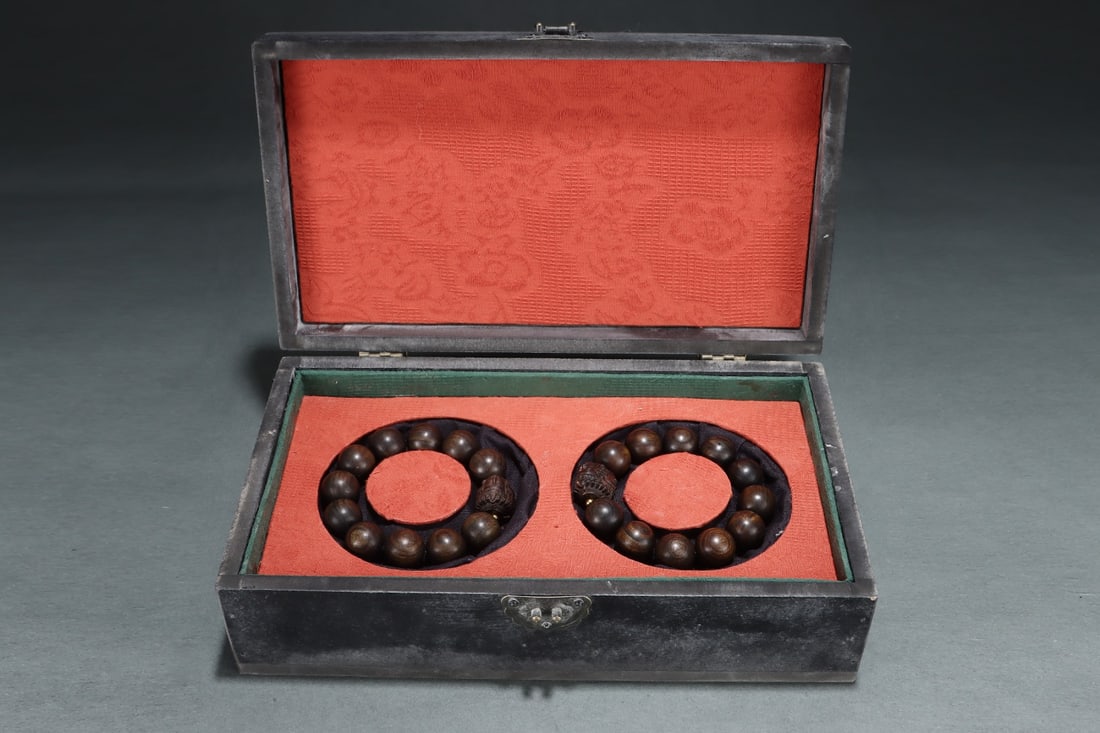 A polished agarwood bracelet from a former imperial collection, featuring a three-faced Guanyin: A court-collected agarwood bracelet with a smooth surface and a three-faced Guanyin statue; diameter: 2 cm. Provenance:from the collection of George Stopher, Kent, purchased from P&M Waldo Antiques,
