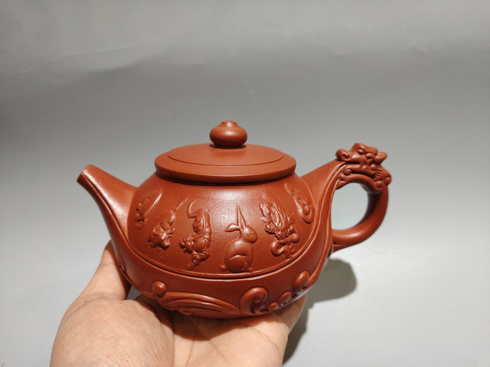 Twelve Zodiac Teapot: Product Name: Chinese Zodiac Teapot (Lower Mark): Made in the Qianlong Period Size: 17 x 9 cm Capacity: 360 cc Clay: Original Red Clay Provenance:from the collection of George Stopher, Kent, purchased
