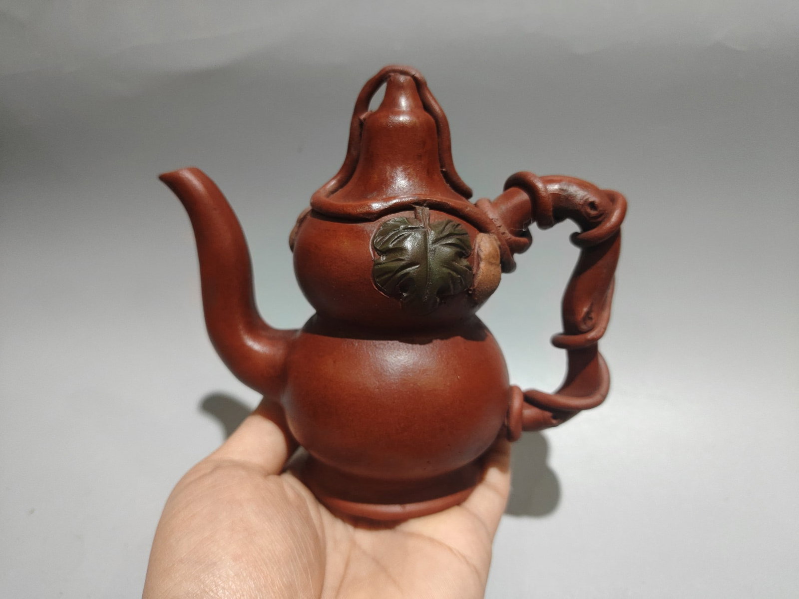 Gourd-shaped backflow pot: Product Name: Gourd-Shaped Backflow Teapot; Bottom Mark: Gu Jingzhou; Size: 15 x 13 cm; Capacity: 240 cc; Clay: Original Red Clay Provenance:Private collection from a professor in University of
