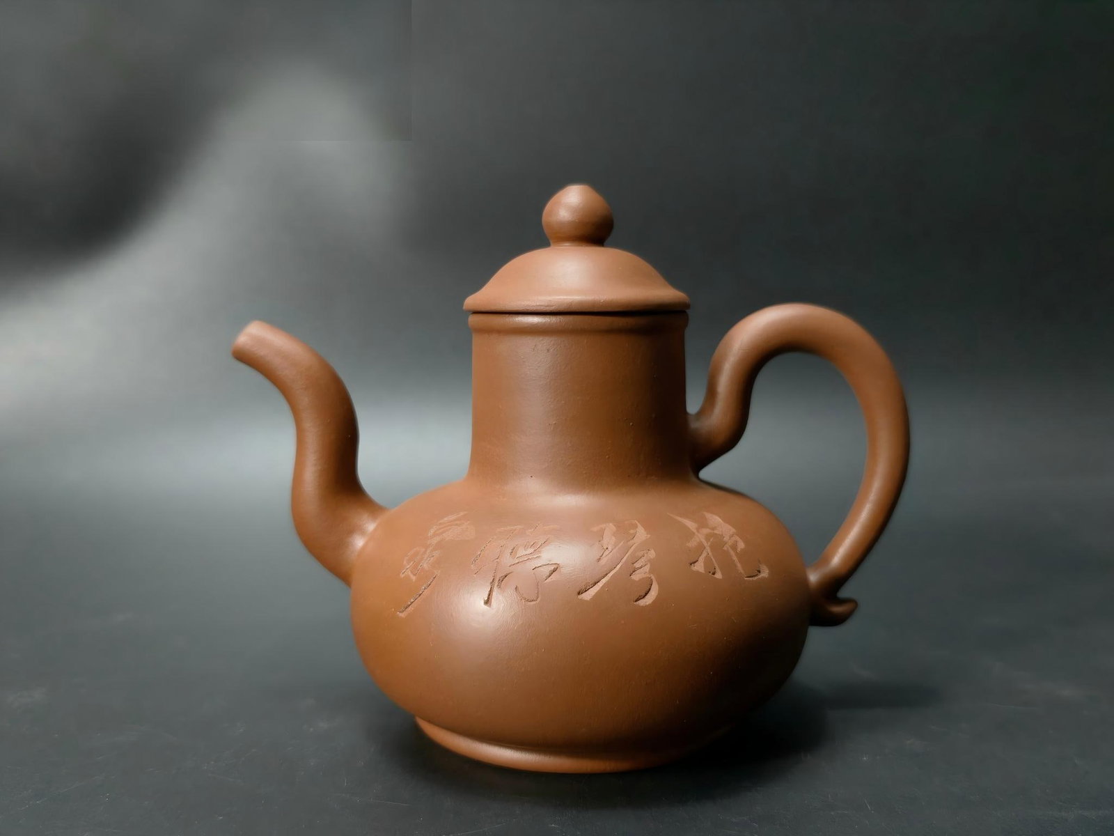 Formerly owned by Huang Yulin, a purple clay teapot: This is a formerly owned Zisha teapot made by Huang Yulin. The clay is warm and smooth, the shape elegant and upright, with rounded, flowing lines. The lid fits perfectly with the spout. The body is