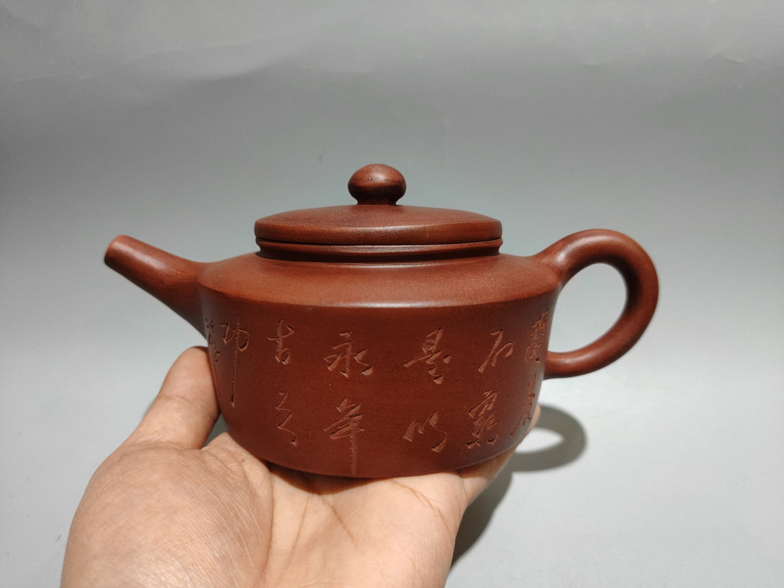 Engraved Biande Bell Pot: Product Name: Engraved Flat Bell Teapot; Bottom Mark: Chen Mansheng, Amantuo Studio; Size: 19 x 9 cm; Capacity: 360 cc; Clay: Original Red Clay Provenance:Private collection from a professor in