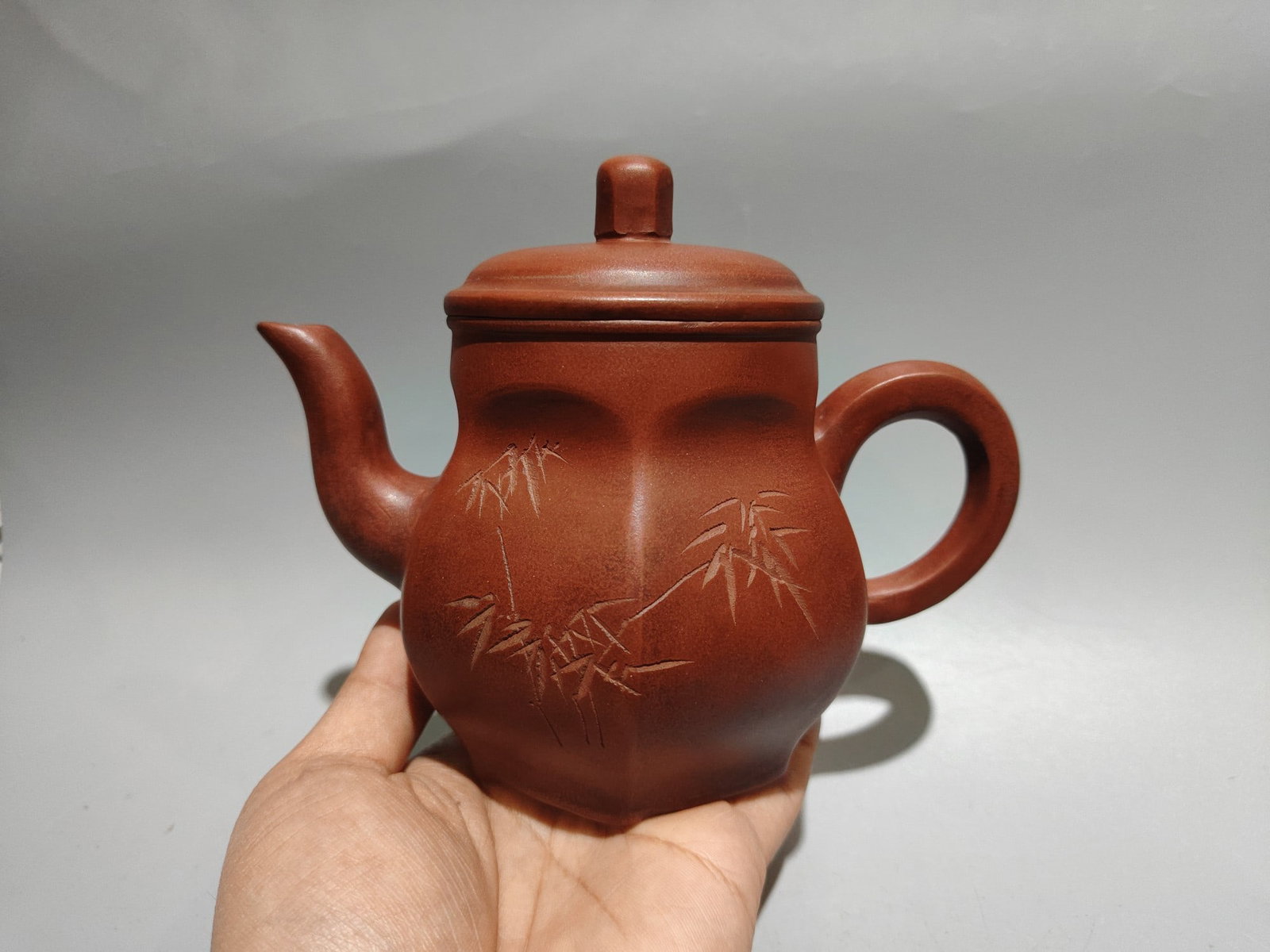 Inscribed hexagonal teapot: Product Name: Engraved Hexagonal Teapot; Bottom Mark: Chen Mansheng, Amantuo Studio; Size: 17 x 14 cm; Capacity: 360 cc; Clay: Original Red Clay Provenance:Private collection from a professor in