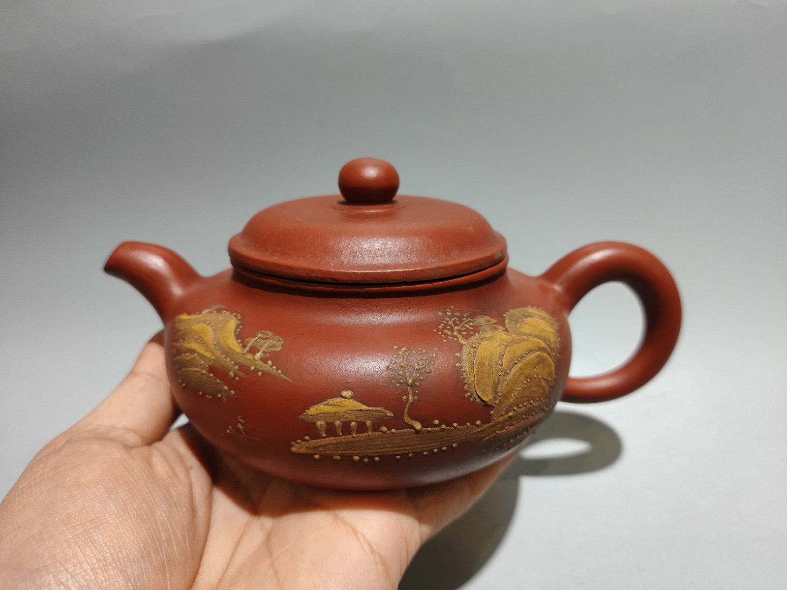 Clay-painted antique-style teapot: Product Name: Antique-Style Teapot with Clay Painting; Bottom Mark: Made by Hui Mengchen; Size: 18 x 8 cm; Capacity: 300cc; Clay: Original Red Clay Provenance:Private collection, Liverpool, The