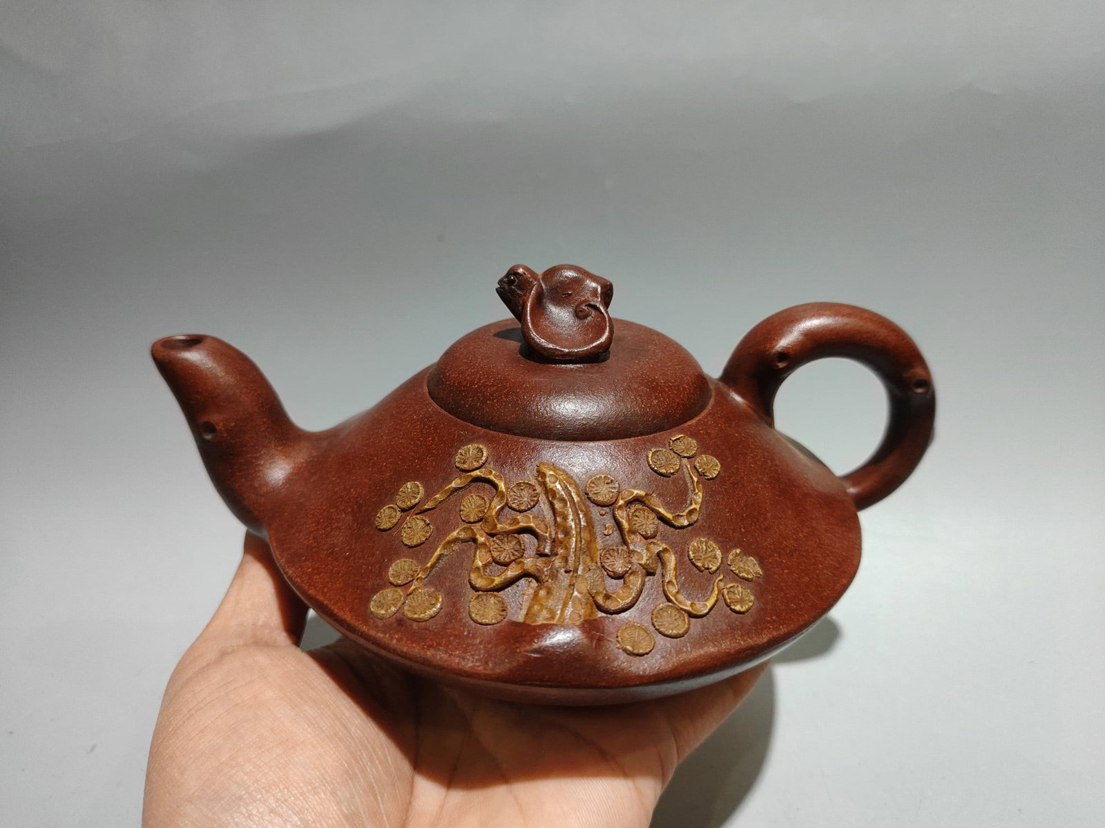 Pine Needle Bat Pot: Product Name: Pine Needle and Bat Teapot; Bottom Mark: Chen Mingyuan; Size: 20 x 10 cm; Capacity: 380 cc; Clay: Original Red Clay Provenance:Private collection, Liverpool, The United Kingdom. We have