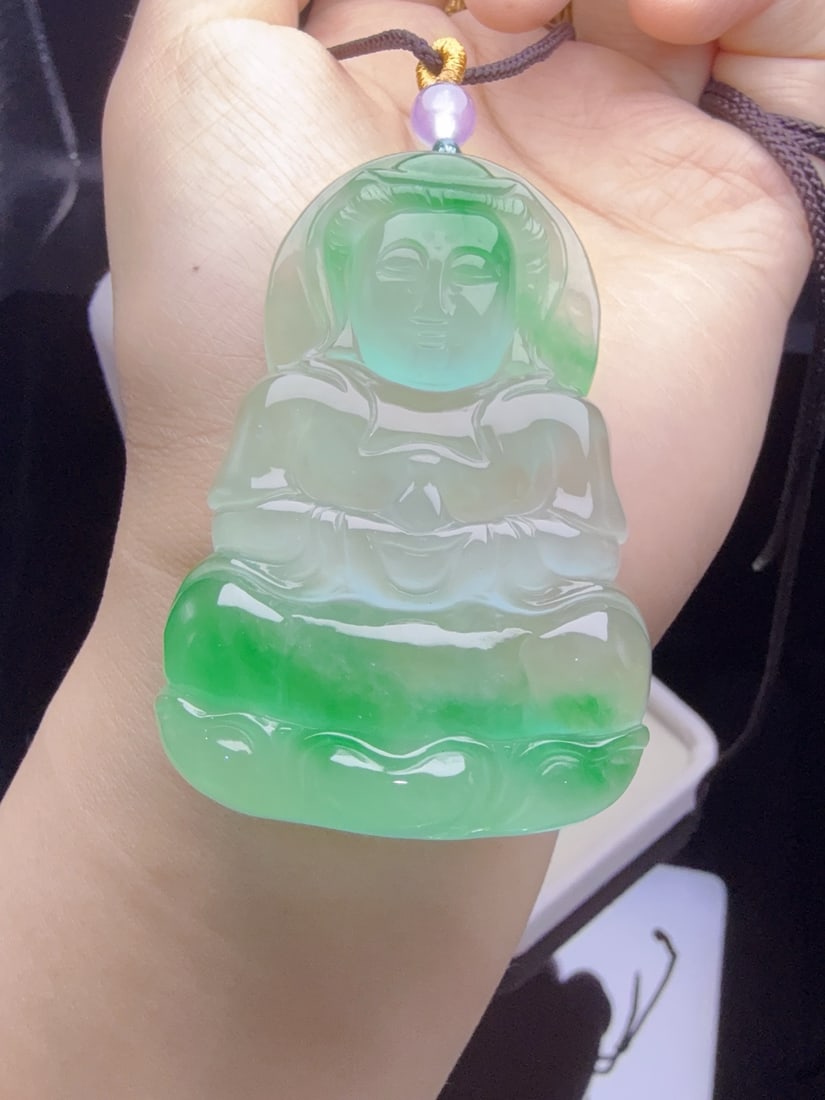 Jadeite "Guanyin" with icy green inclusions: This jadeite "Guanyin" piece, made of icy jade with floating green hues, is translucent and lustrous, exquisitely three-dimensional, thick and full, and perfectly flawless. Provenance:From an old priv