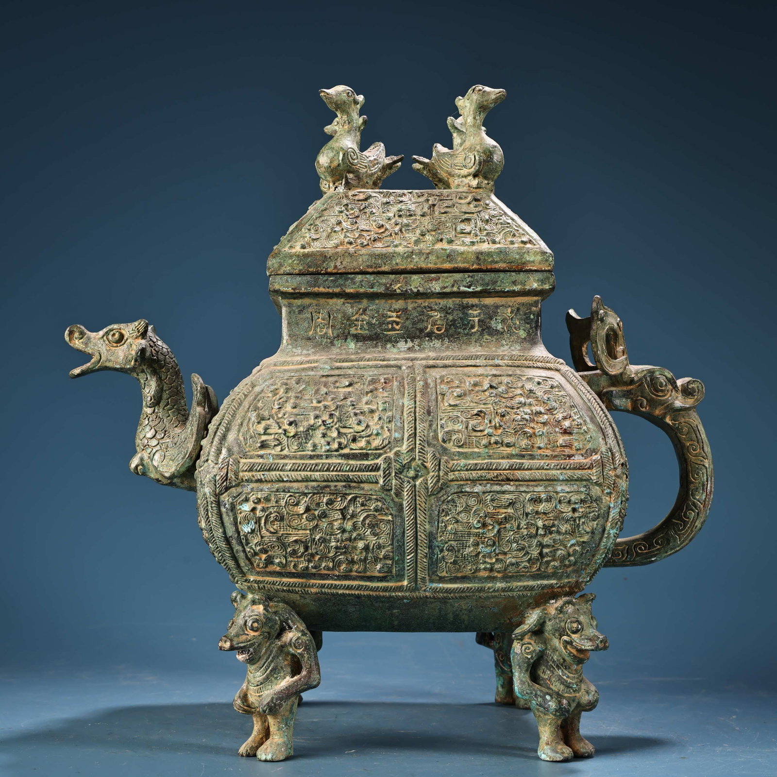 Rare bronze square bird-shaped covered pot with inscription from a rare collection: This is a bronze kneeling figure from the Shang Dynasty, imbued with the mysterious atmosphere of ancient Shu culture. The figure is depicted in a kneeling posture, with a strong facial contour, large