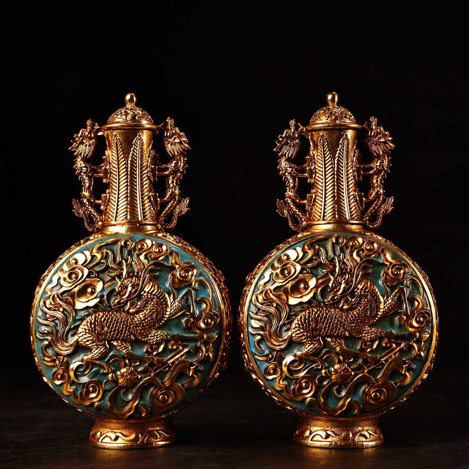 A pair of rare, high-relief, engraved, filigree, and gilt snuff bottles from a distinguished: A pair of exquisitely crafted, high-relief, filigree, and gilt snuff bottles from a rare collection. Each bottle is beautifully designed and weighs 550 grams. They are 17 cm high and 10 cm wide. Prove