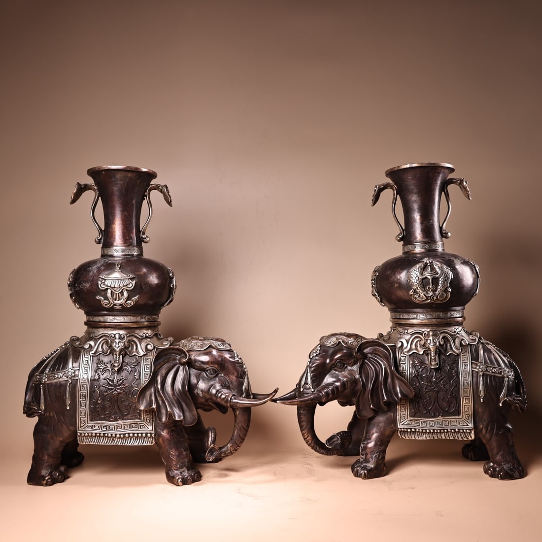 A pair of Nepalese Tibetan-style high-relief bronze vases with engraved silver Tibetan auspicious: A pair of pure copper high-relief Tibetan-style elephant vases with auspicious eight treasures, crafted in Nepal and Tibet. Exquisitely crafted and beautifully designed. Weighs 5000 grams, 42 cm high,
