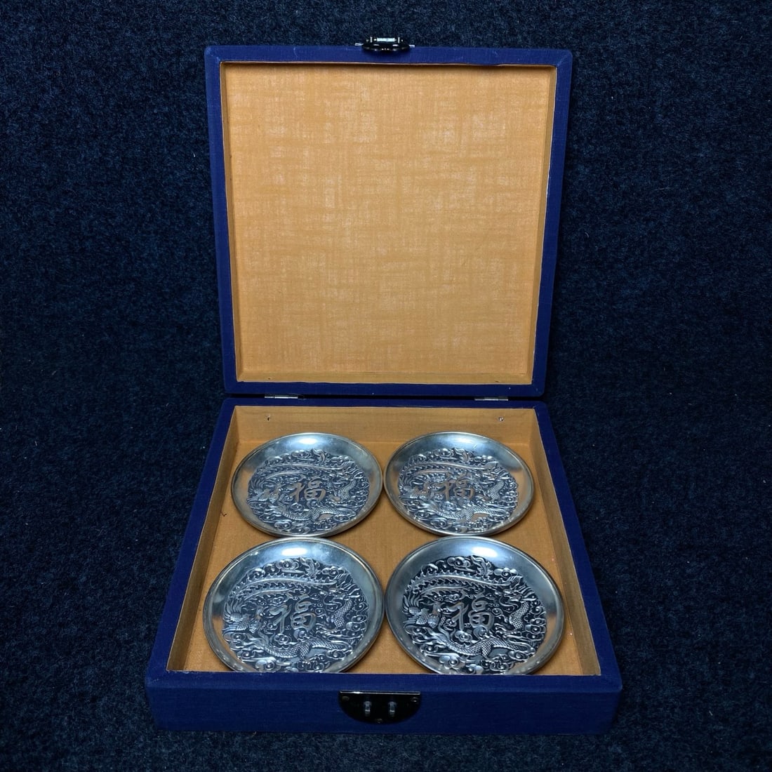 white bronze gilded silver appreciation plate is treasured inside a royal embroidery collection box.: The imperial embroidery collection box contains a precious white bronze gilded silver appreciation plate. The plate's dimensions are: diameter 10.8 cm. The embroidery box's dimensions are: length/widt